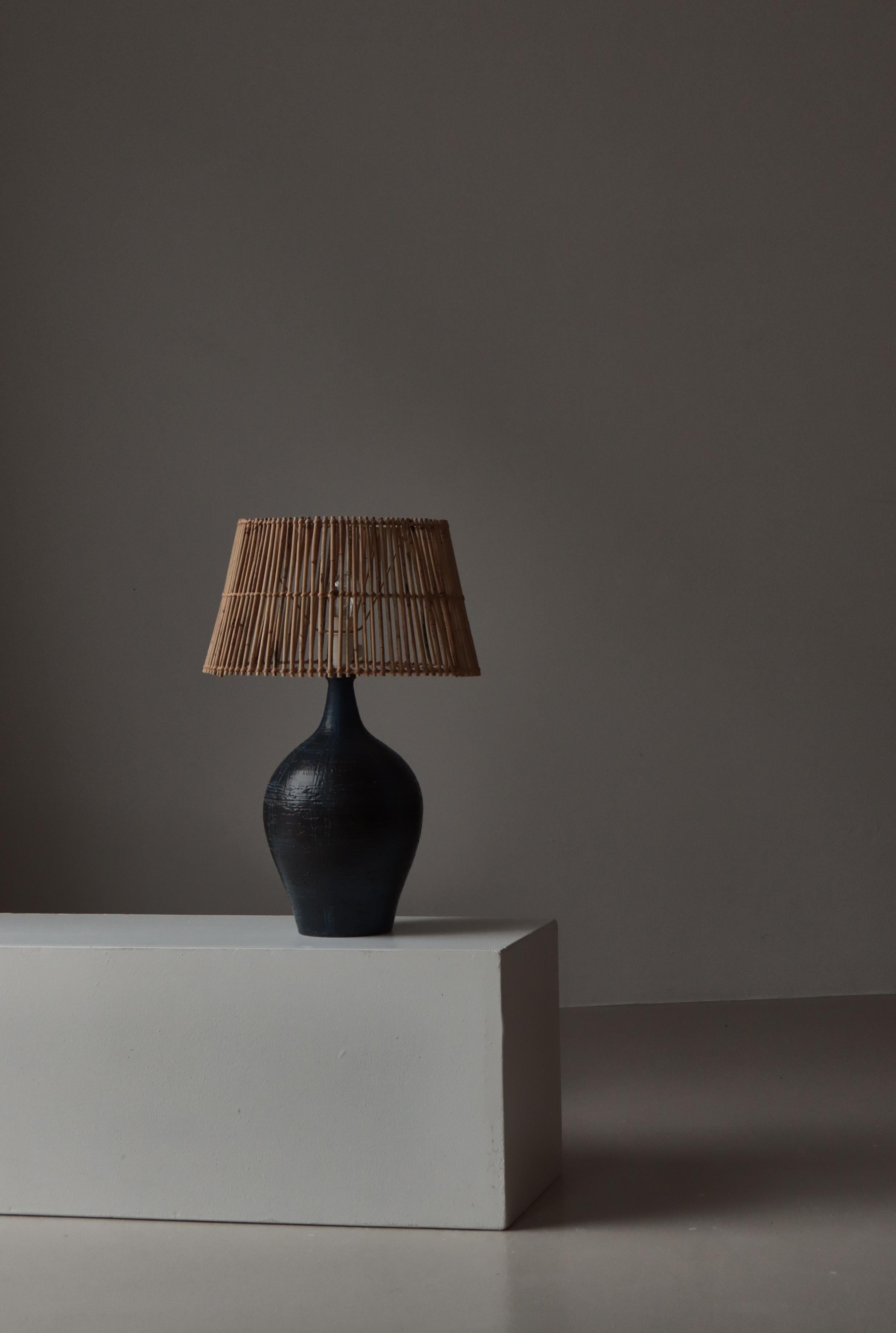 A striking large stoneware table lamp by Sejer Ceramics, Denmark, dating to the 1960s. The piece features a beautifully balanced, hand-thrown body with a deep charcoal glaze accented by expressive cobalt blue incised brushwork. The surface displays