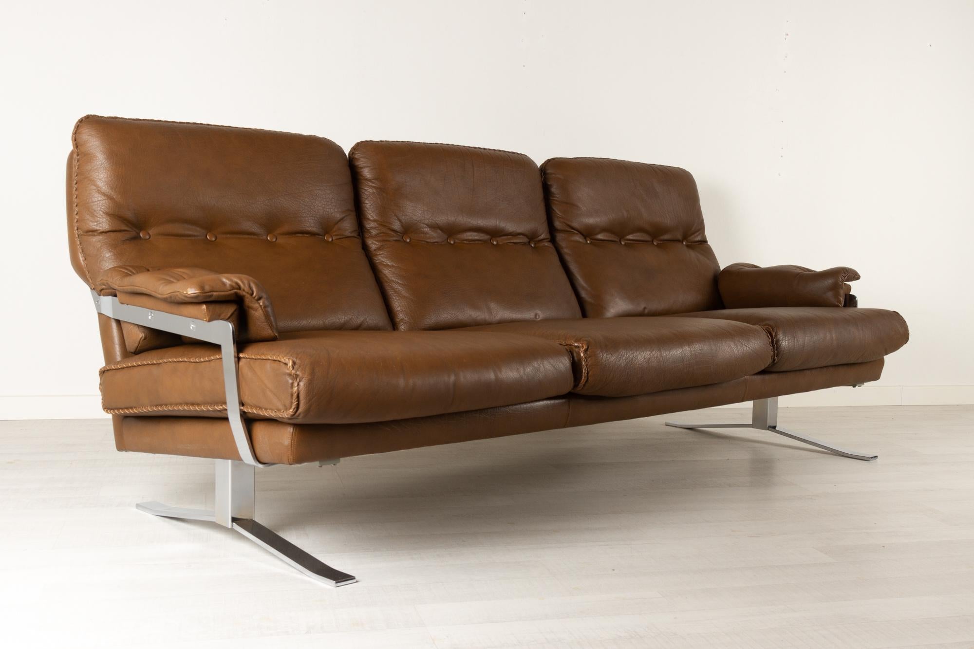 Scandinavian Modern leather and chrome sofa by Arne Norell, 1970s
Chocolate brown three seater sofa in buffalo leather. Large soft cushions with buttons and hand stitched edges. Very thick and soft leather. Legs and armrests in chromed