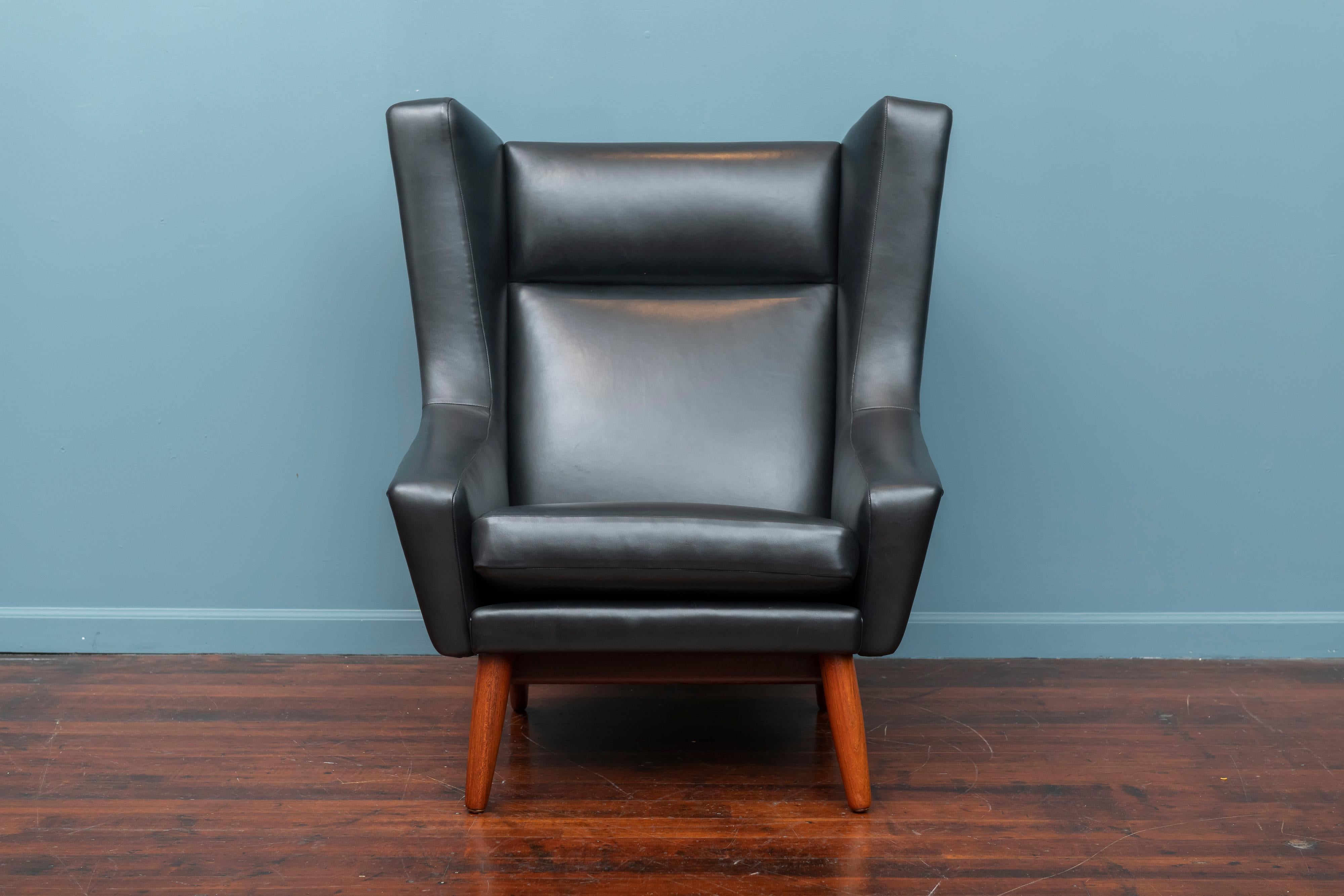 Scandinavian Modern teak and leather lounge chair. Dramatic angular design just newly refinished and upholstered in Italian black leather super comfy.