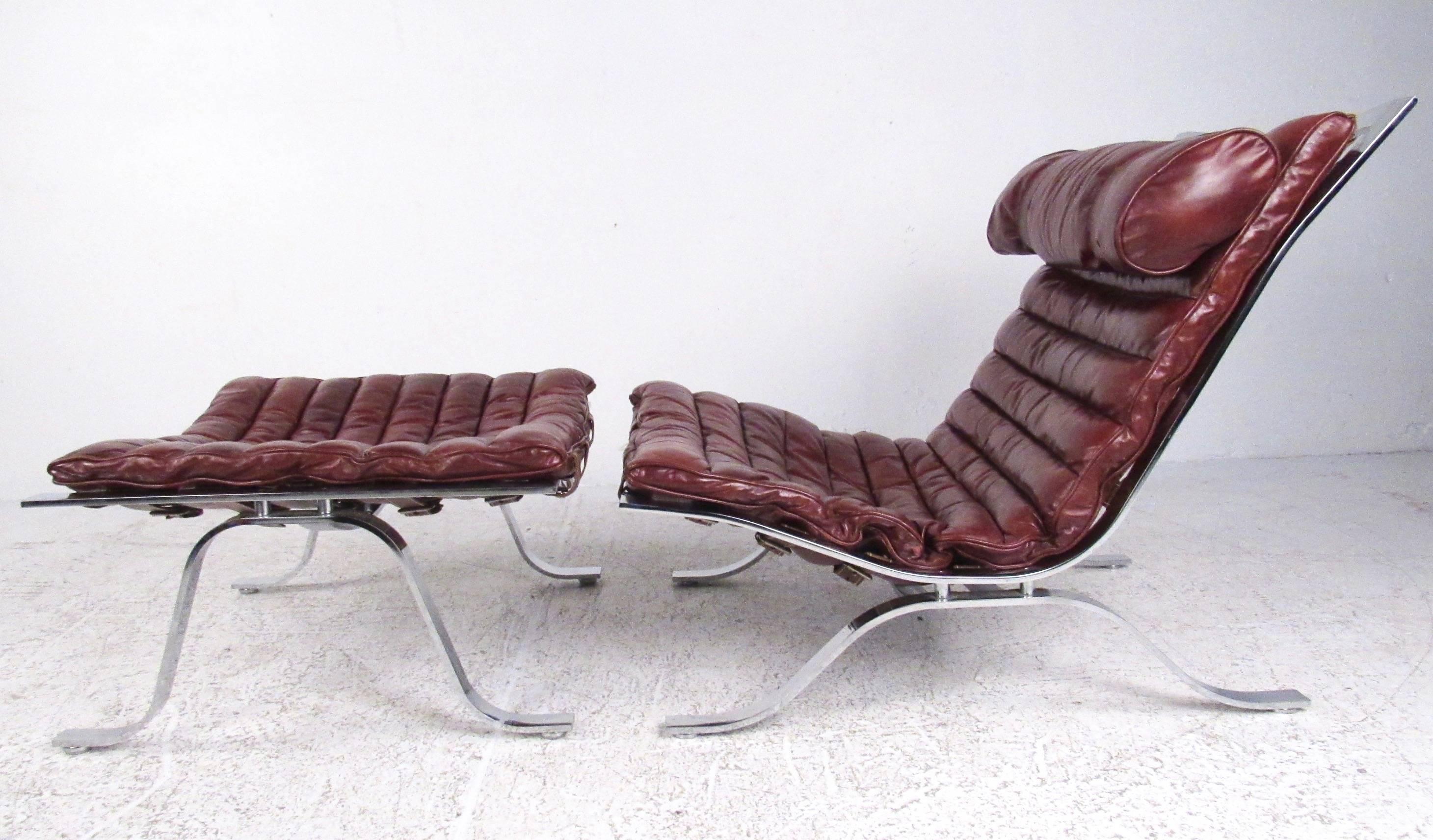 This quality midcentury Swedish lounge chair features comfortable ribbed leather upholstery, matched head rest, and heavy chrome construction. Matching ottoman adds to the comfort of this mid century modern slipper chair, perfect for home or