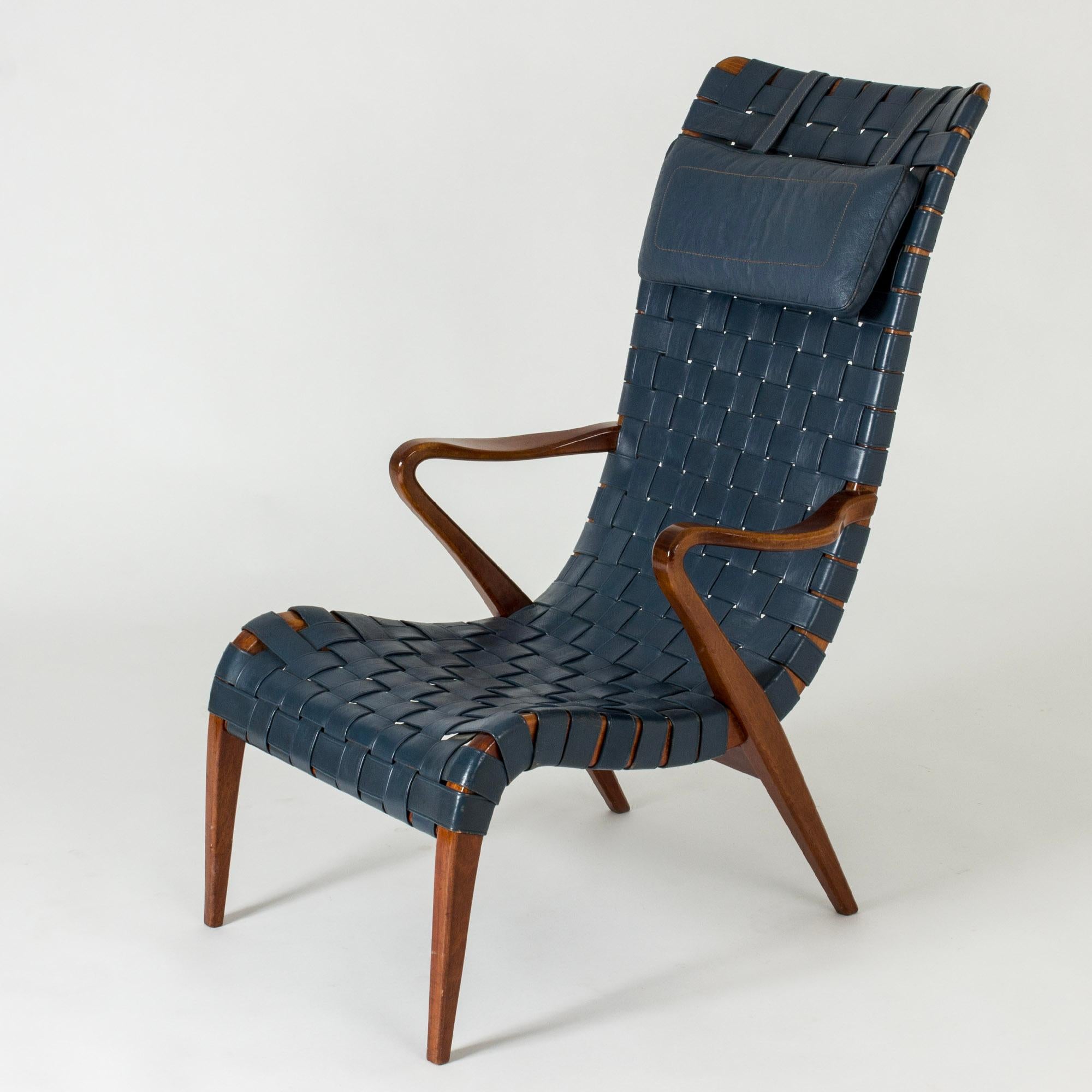Amazing lounge chair by Axel Larsson, made from teak with original wreathed blue leather. Neck cushion. Bold lines create a very cool silhouette.