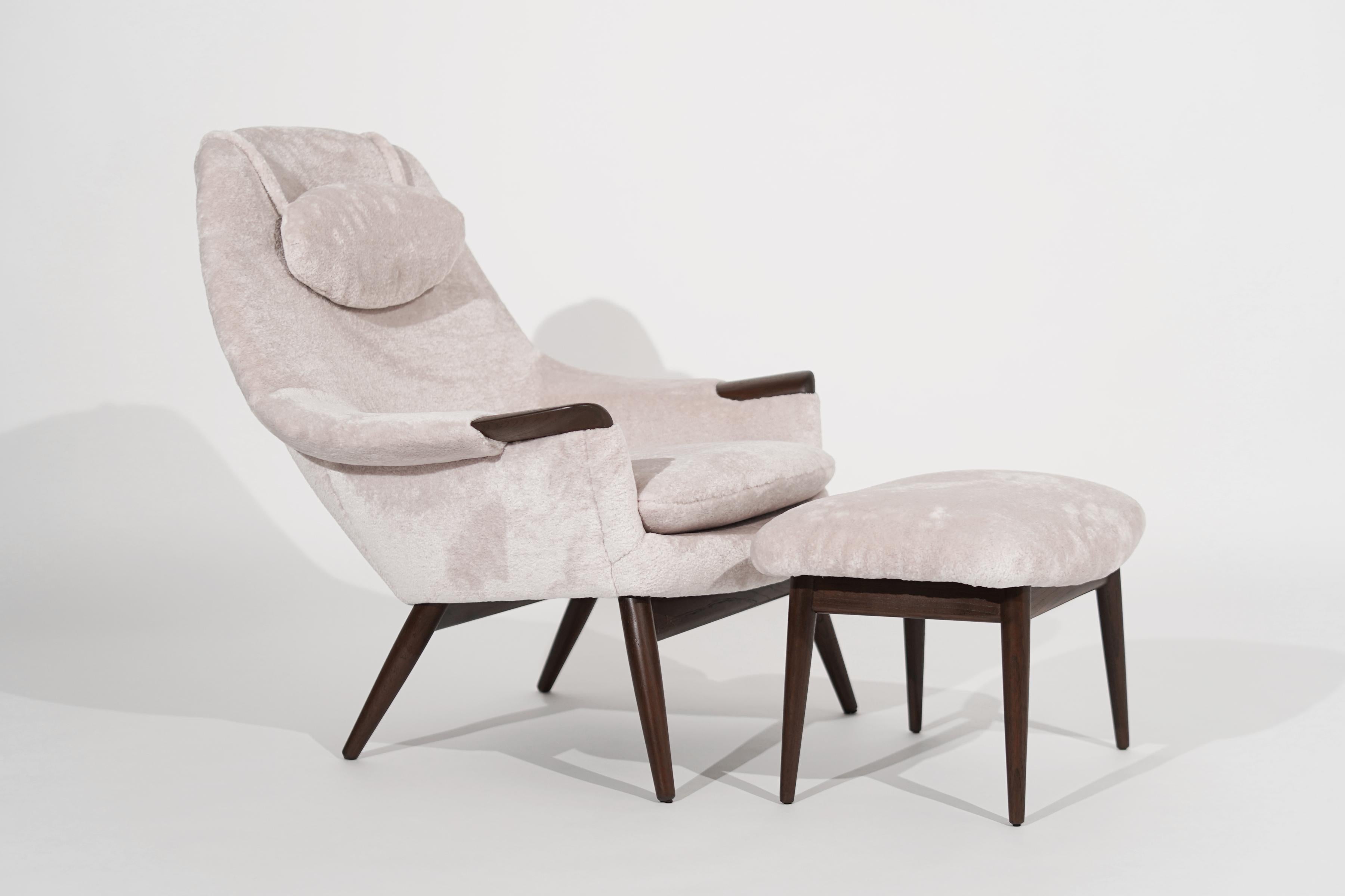 An exquisite lounge chair and footstool, featuring subtle curves, teak details, and super soft cotton/wool upholstery. Designed Gerhard Berg, Denmark, circa 1950-1959. Completely restored.

