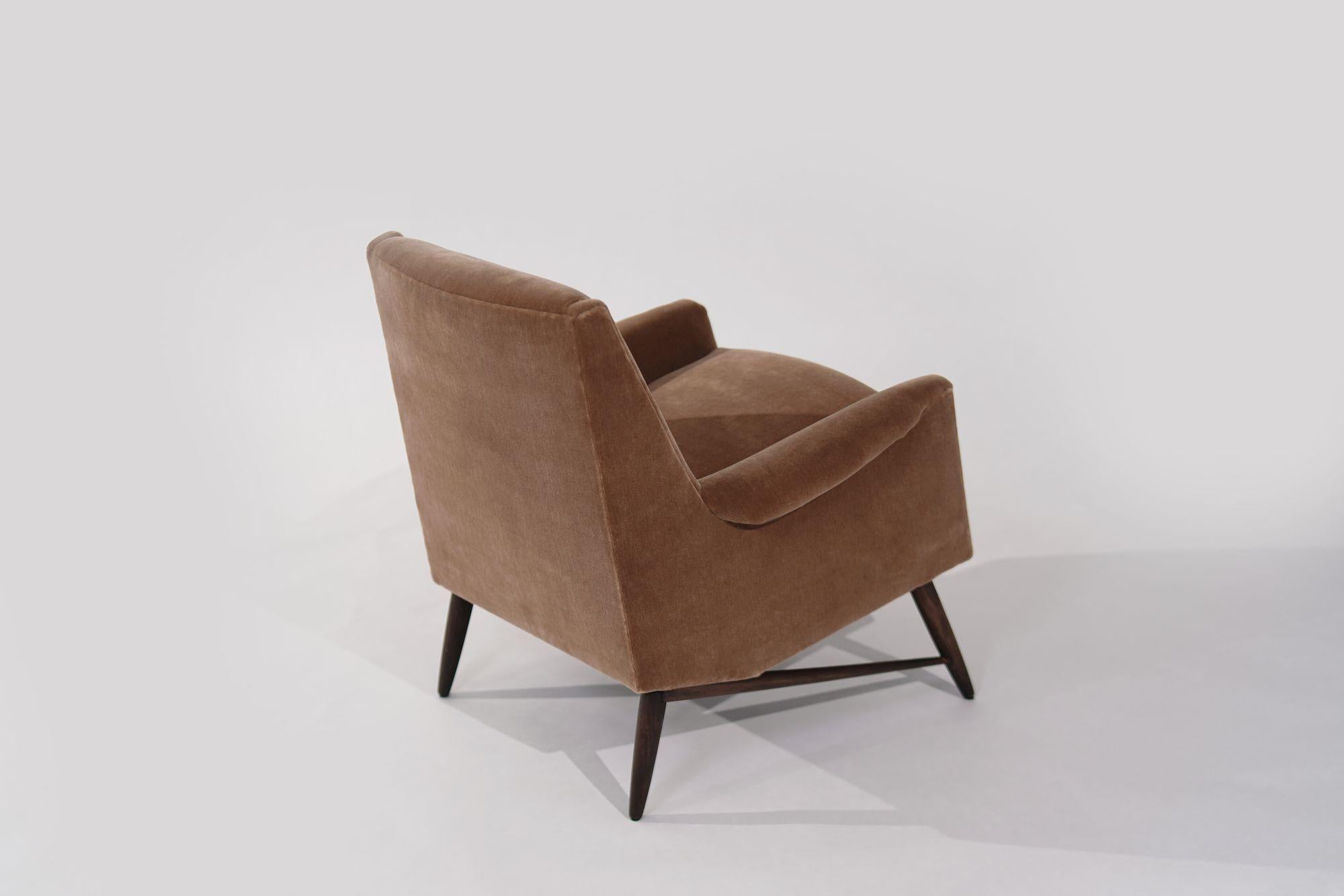 Discover timeless elegance with this Scandinavian-Modern lounge chair from the 1950s. Meticulously restored and reupholstered in luxurious gold mohair, it epitomizes mid-century charm and sophistication. A statement piece for any room, blending