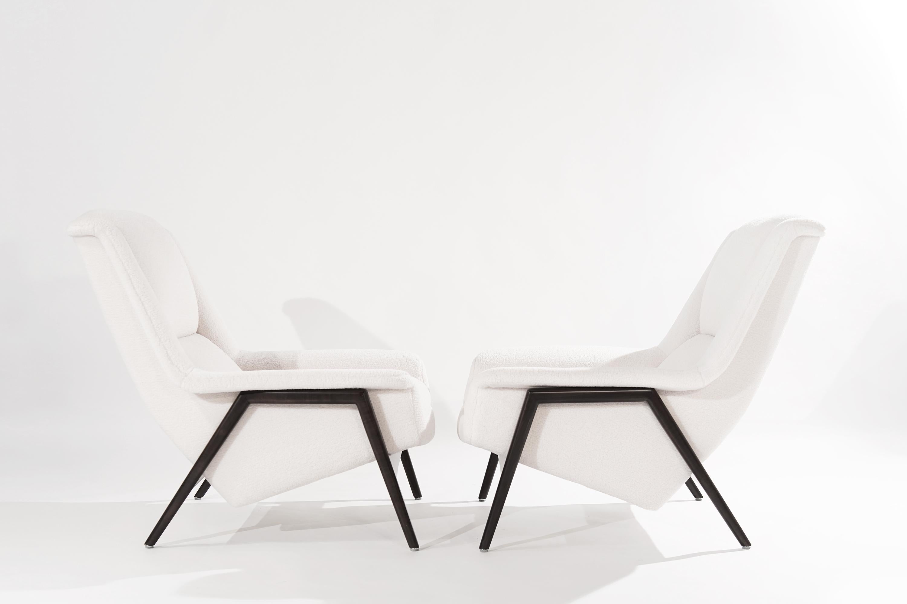 Stunning pair of large profile Scandinavian-Modern lounge chairs designed by Folke Ohlsson for DUX of Sweden, circa 1960s.

Signature teak frames have been fully restored and ebonized rendering the perfect contrast to their new off-white wool