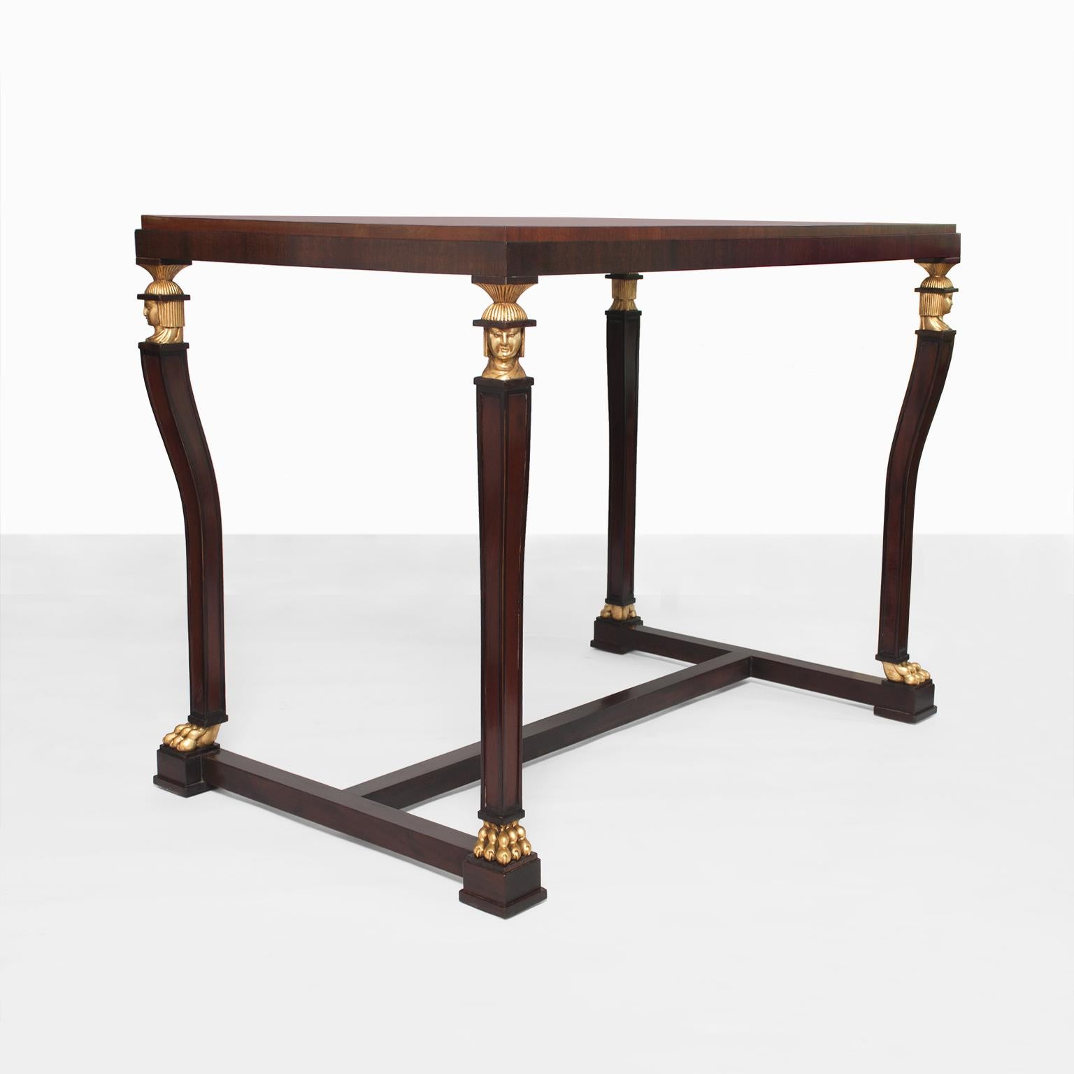 A stunning Scandinavian Modern, Swedish grace period (1920s) solid mahogany console or centre table with carved and parcel-gilt caryatid heads and claw feet. The top is veneered with Cuban flame mahogany. Exceptional quality, fully