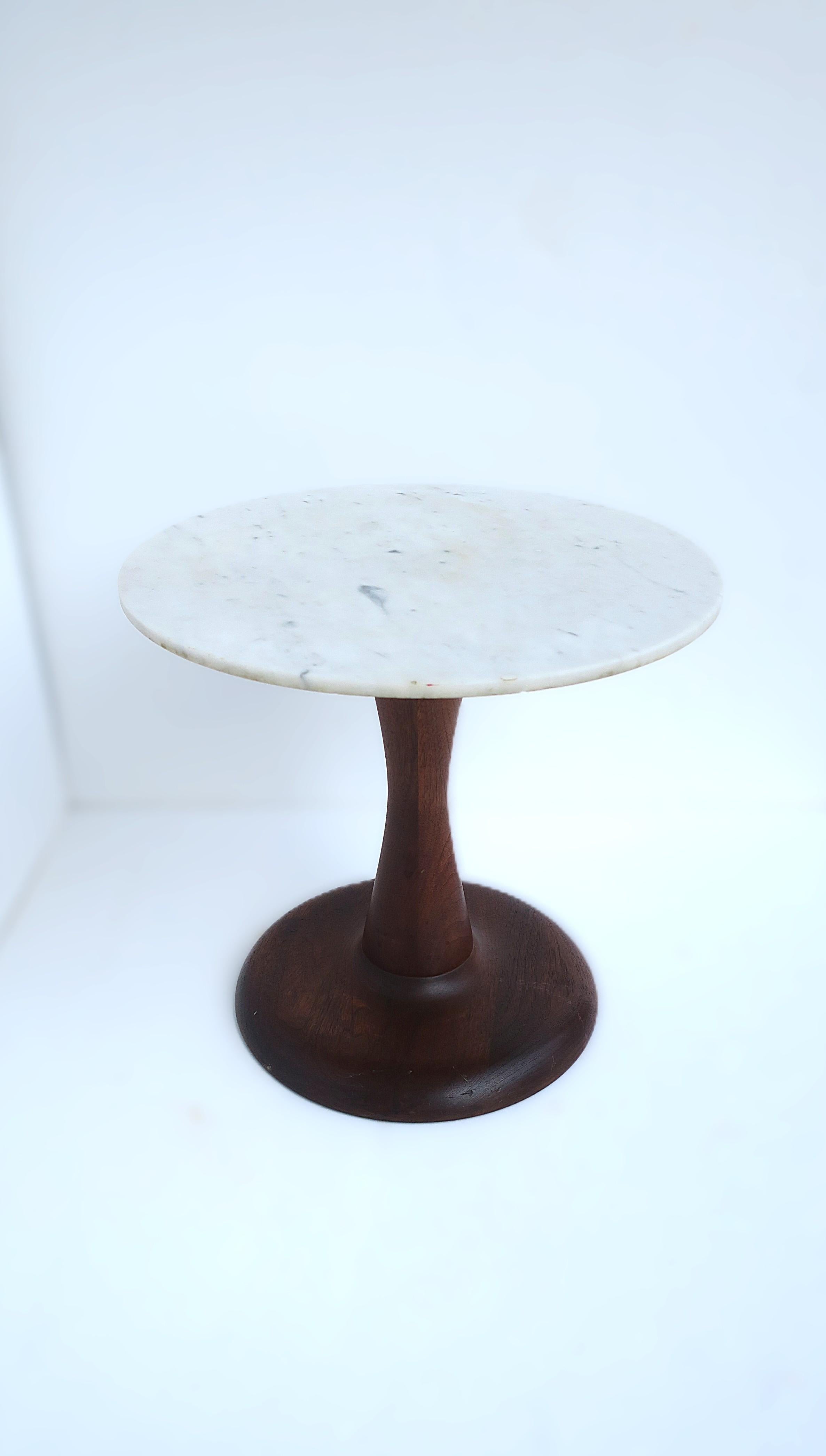 A Danish round marble and wood side drinks table, Scandinavian/Danish Modern design period, circa mid-20th century, Denmark. Table is of Scandinavian/Danish design with a beautiful smooth wood base with slight hourglass shape and a white and