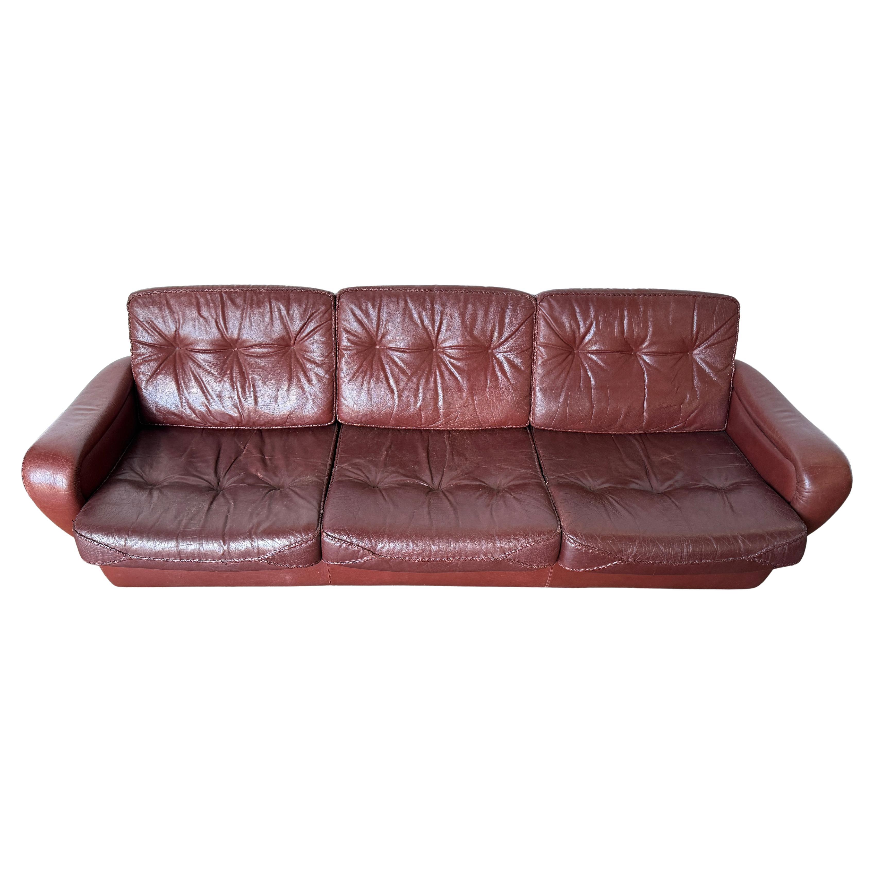 Mid century Danish Modern Maroon leather 3 seat sofa Madsen & Schubell. Leather has woven leather stitching. Danish modern low lounge Sofa. Chrome tapered legs, removable leather cushions. Great Design. Made In Denmark. All original Leather broken