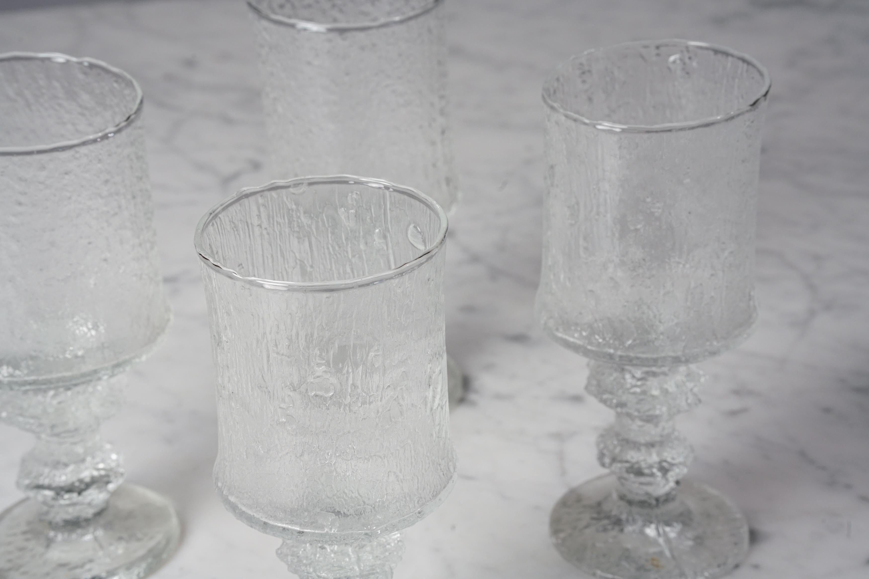 Scandinavian Modern model Festivo 2140 glasses (6 pieces) by Timo Sarpaneva For Iittala, 1970s, glass, good vintage condition, minor wear consistent with age and use. The glass pedestal is large and baroque in size, with a rich and rosy surface. It