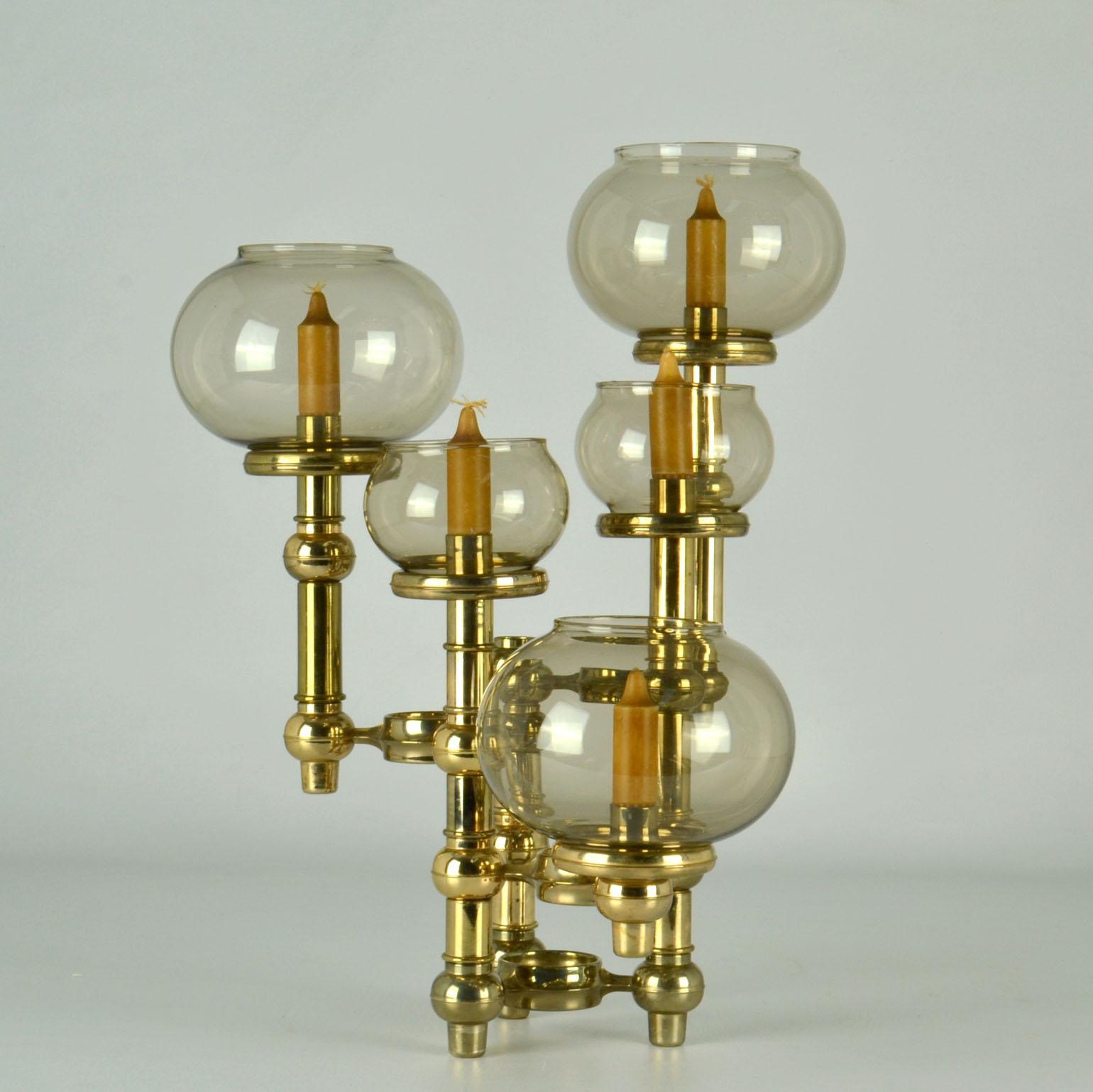 Scandinavian Modern candelabra build with modular 3-legged elements and tubular extensions stacked on top of each other to create a magnificent sculptural table piece created by five arms of various heights with five candles and tinted glass shades