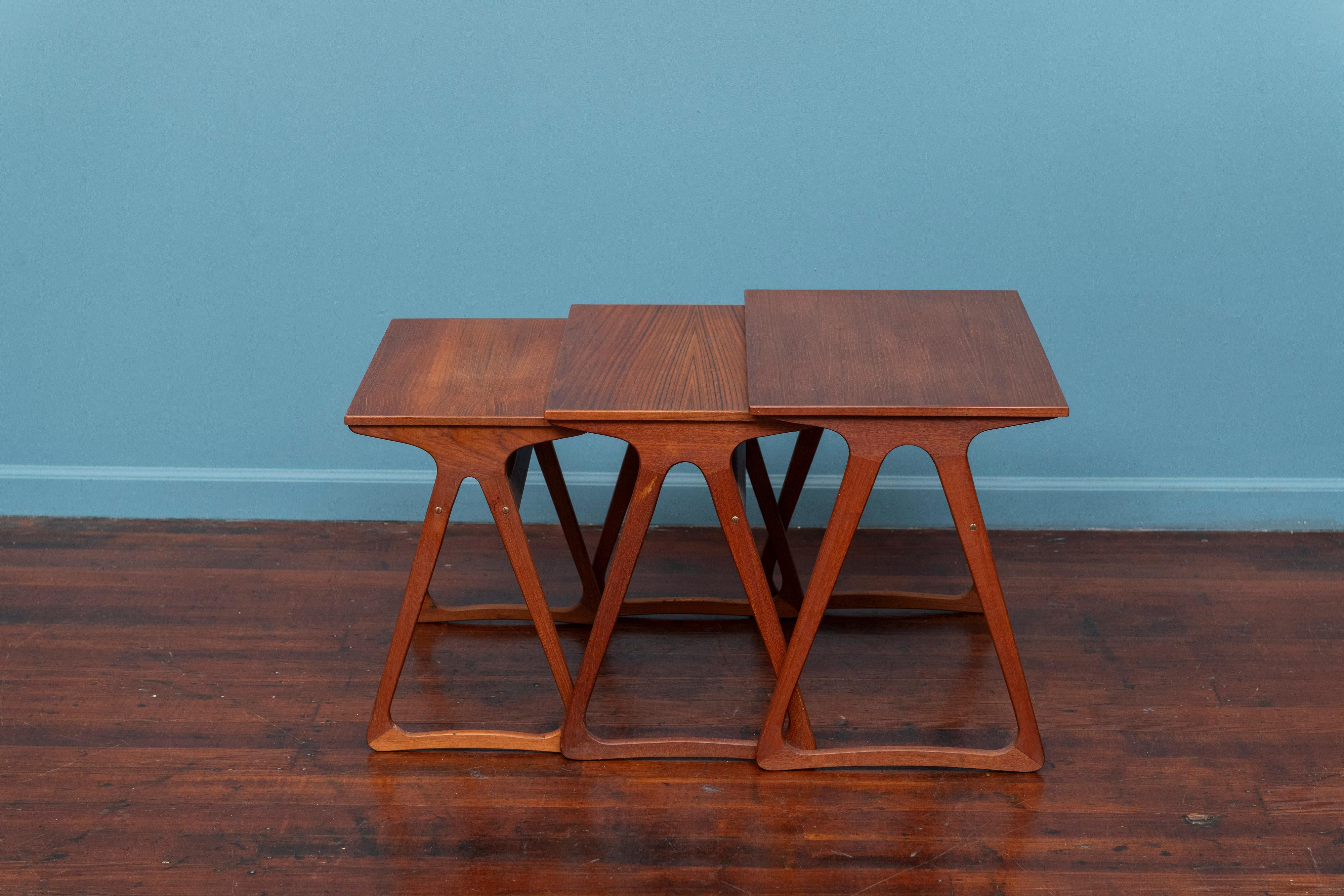 Scandinavian Modern trio of teak nesting tables. High quality construction and materials executed in teak, a multi purpose design. Interesting triangle base that is both appealing and sturdy, ready to install and enjoy.