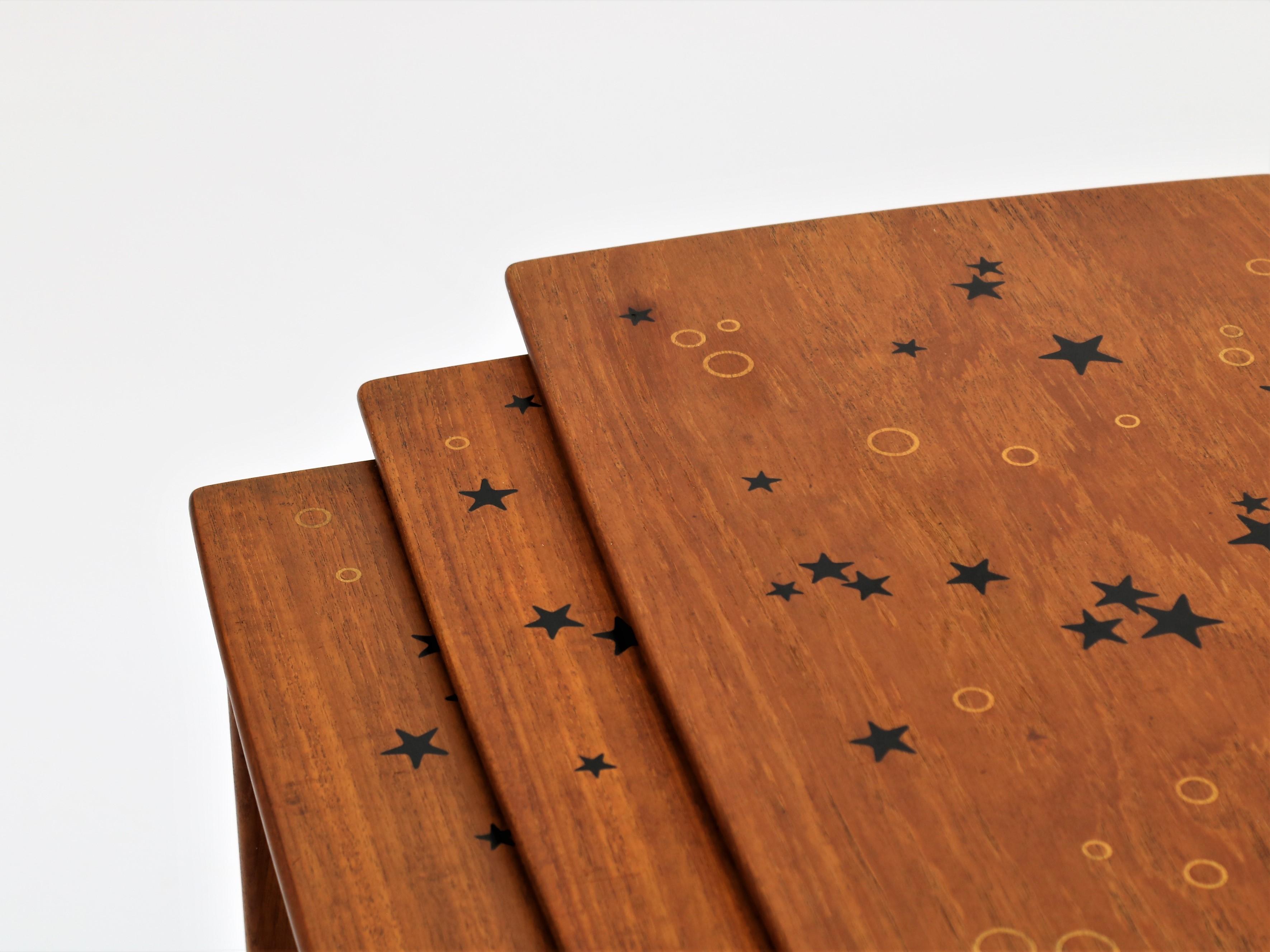 Rare set of Nesting Tables designed by Svend Aage Madsen and produced by Sigurd Hansen Møbelfabrik in Denmark in the 1950s. Teak wood with stylish inlays of stars and circles.