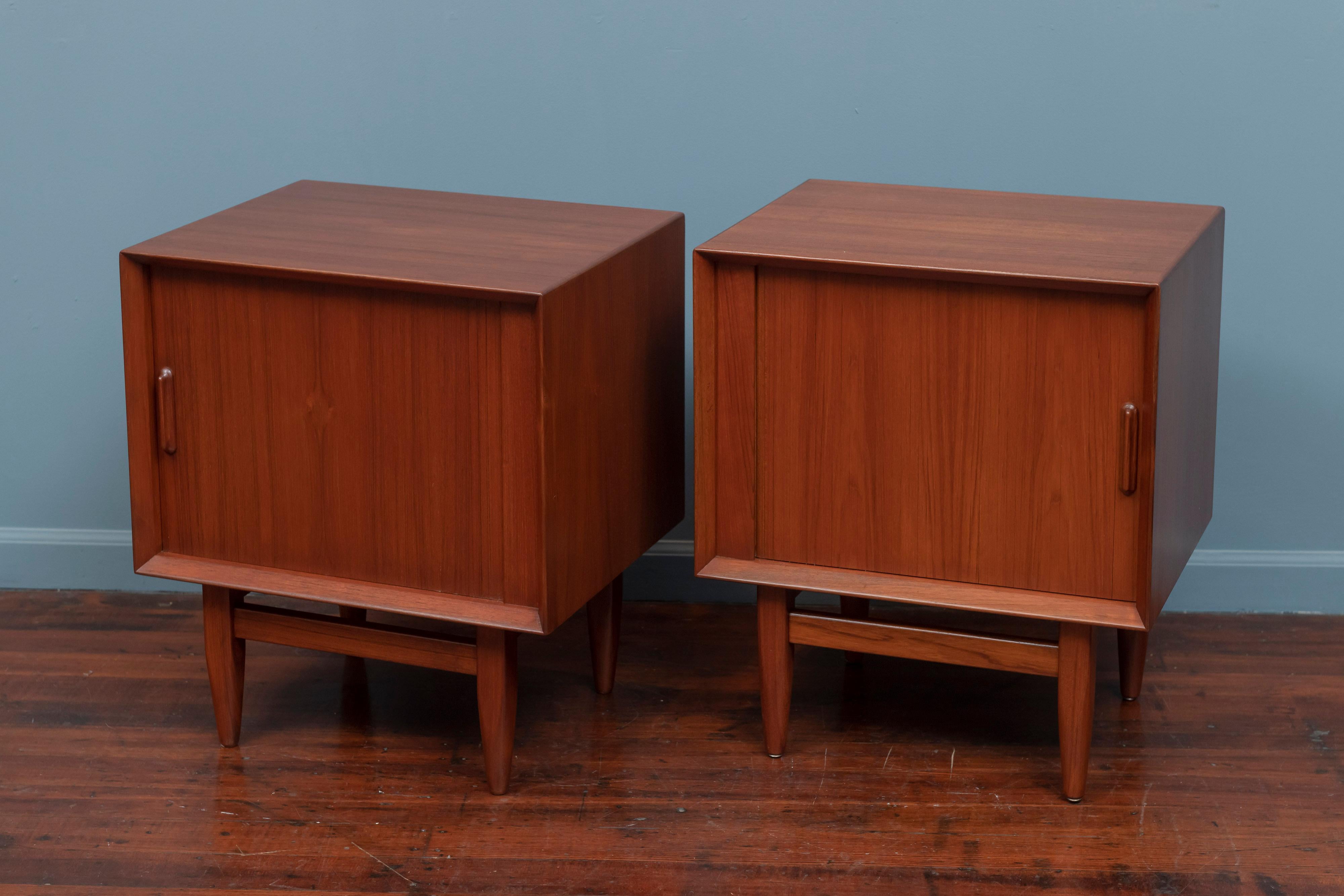 Pair of Scandinavian Modern teak nightstands with tabor doors and contrasting blonde interiors. High quality design and construction newly refinished and ready to install.