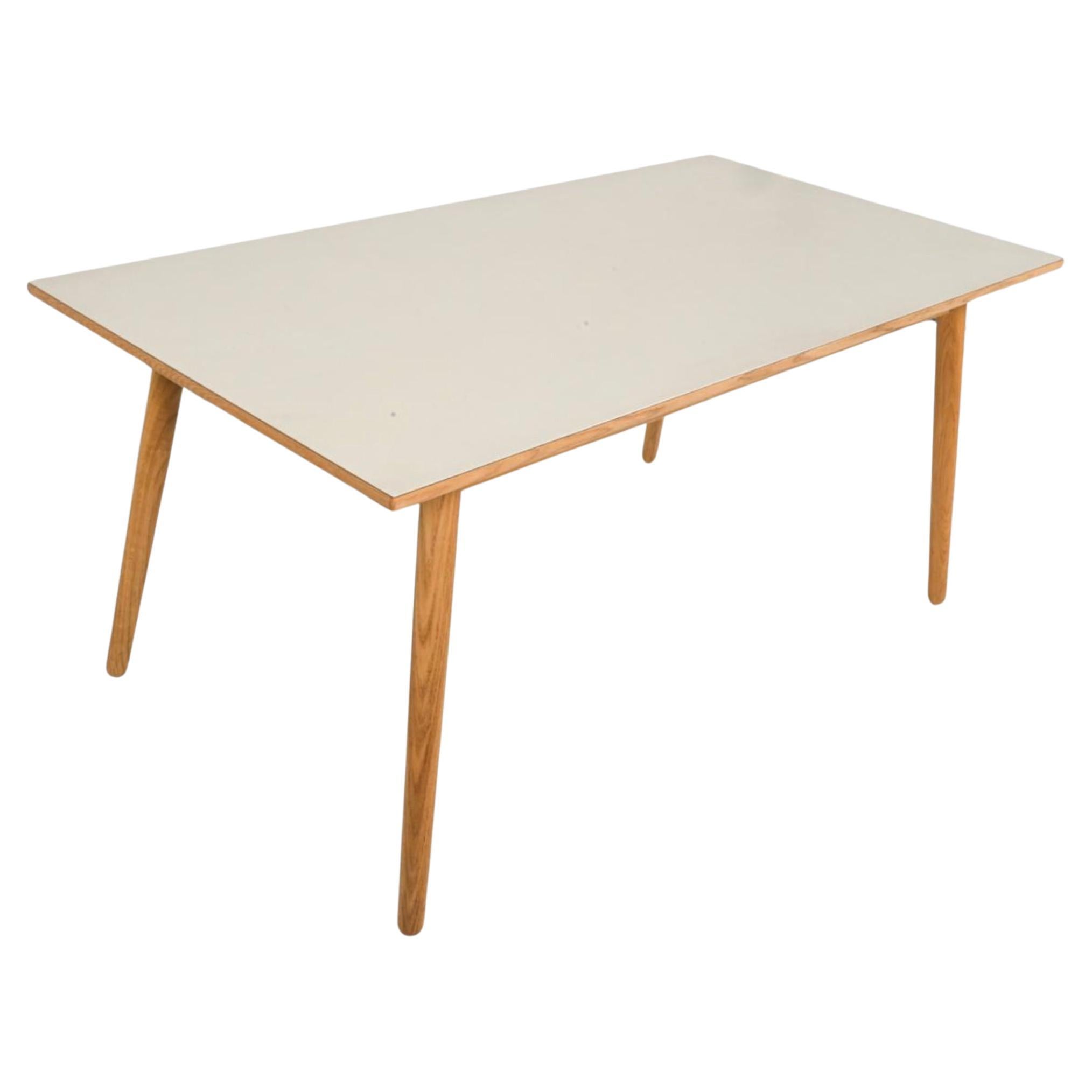 Mid Century Scandinavian Modern off-white Laminate rectangle dining game work table. very light tan - off - white thick Laminate top on a solid Oak table with (4) tapered legs. Fits 4-6 seats chairs. No Leaves or Extensions. No Chips very clean.