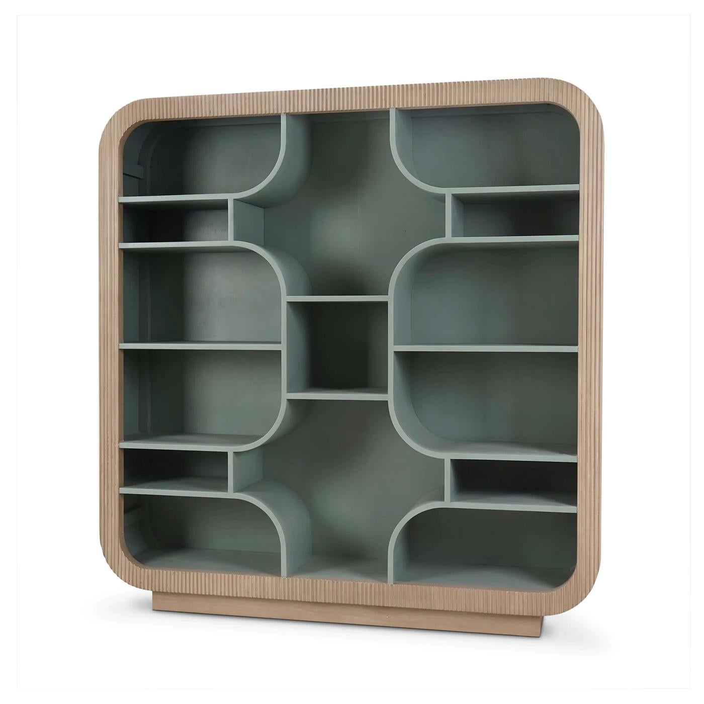 With a modular grid of softly curved cubbies, it offers a visually striking backdrop for books, ceramics, or collected objects. The fluted frame is finished in a light Sandbar tone that highlights its organic profile, while the interior is painted