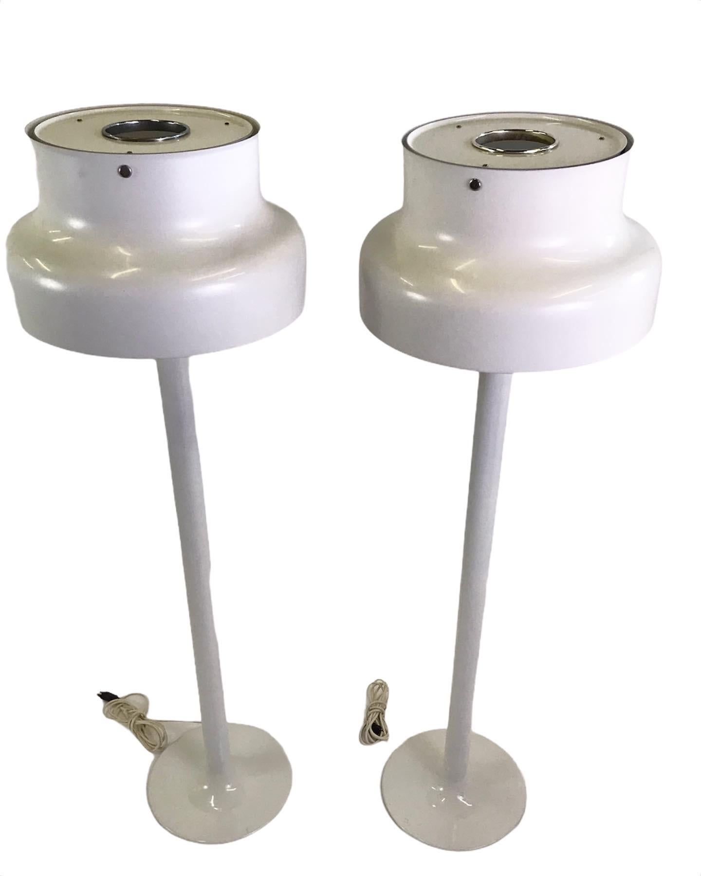 Famed Swedish modern design Bumling floor lamps from 1968 by Anders Pehrson, created while head of design at Atelje Lyktan in Ahus, Sweden. These white lacquered floor lamps are an attractive delight and most utile. With a head of the famous