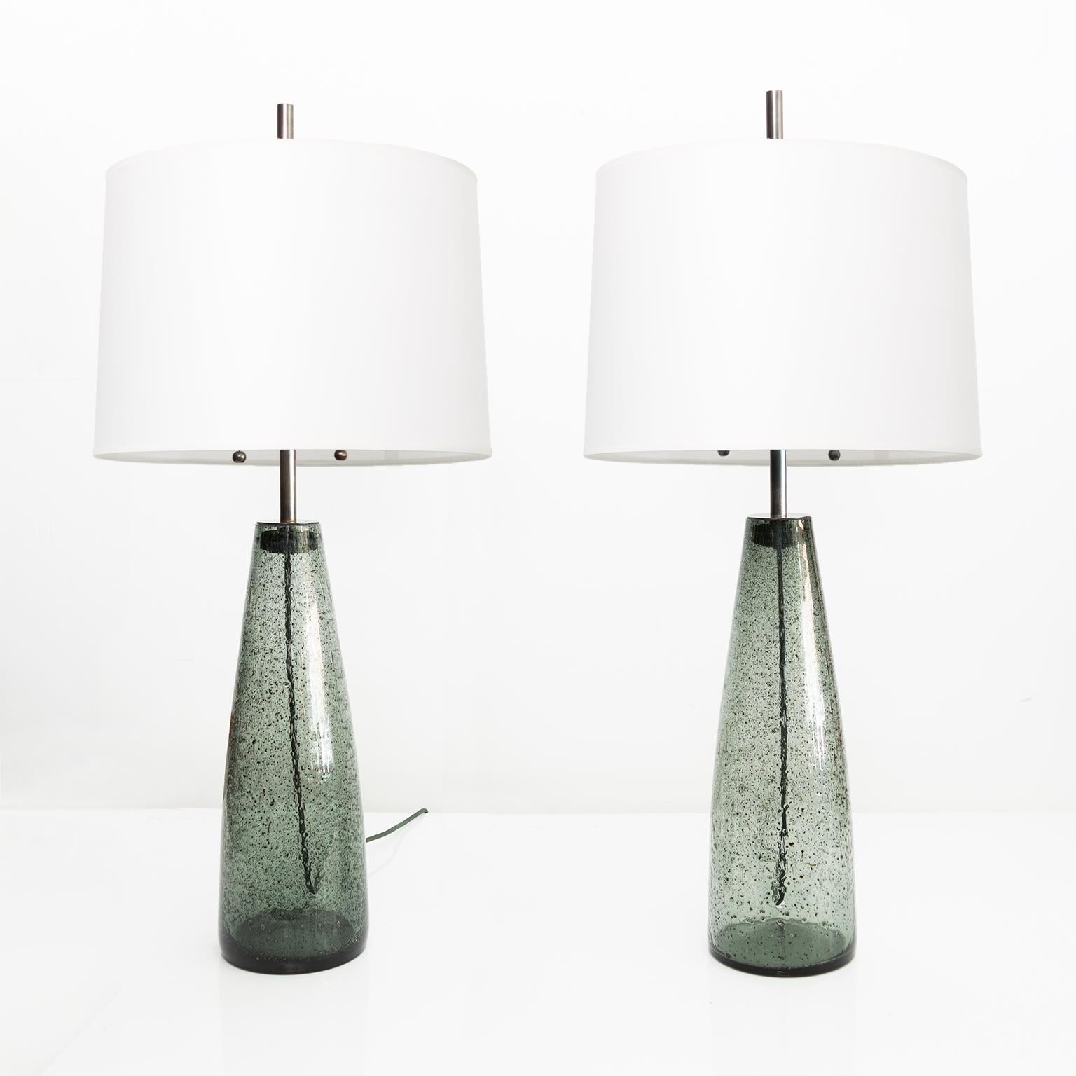 Pair of Scandinavian midcentury “Stromboli” table lamps in a smokey colored glass. Stromboli glass was created by introducing metallic powder during the blowing process. Designed by Bengt Orup and made by Hyllinge Glasbruk, Sweden, circa 1960’s