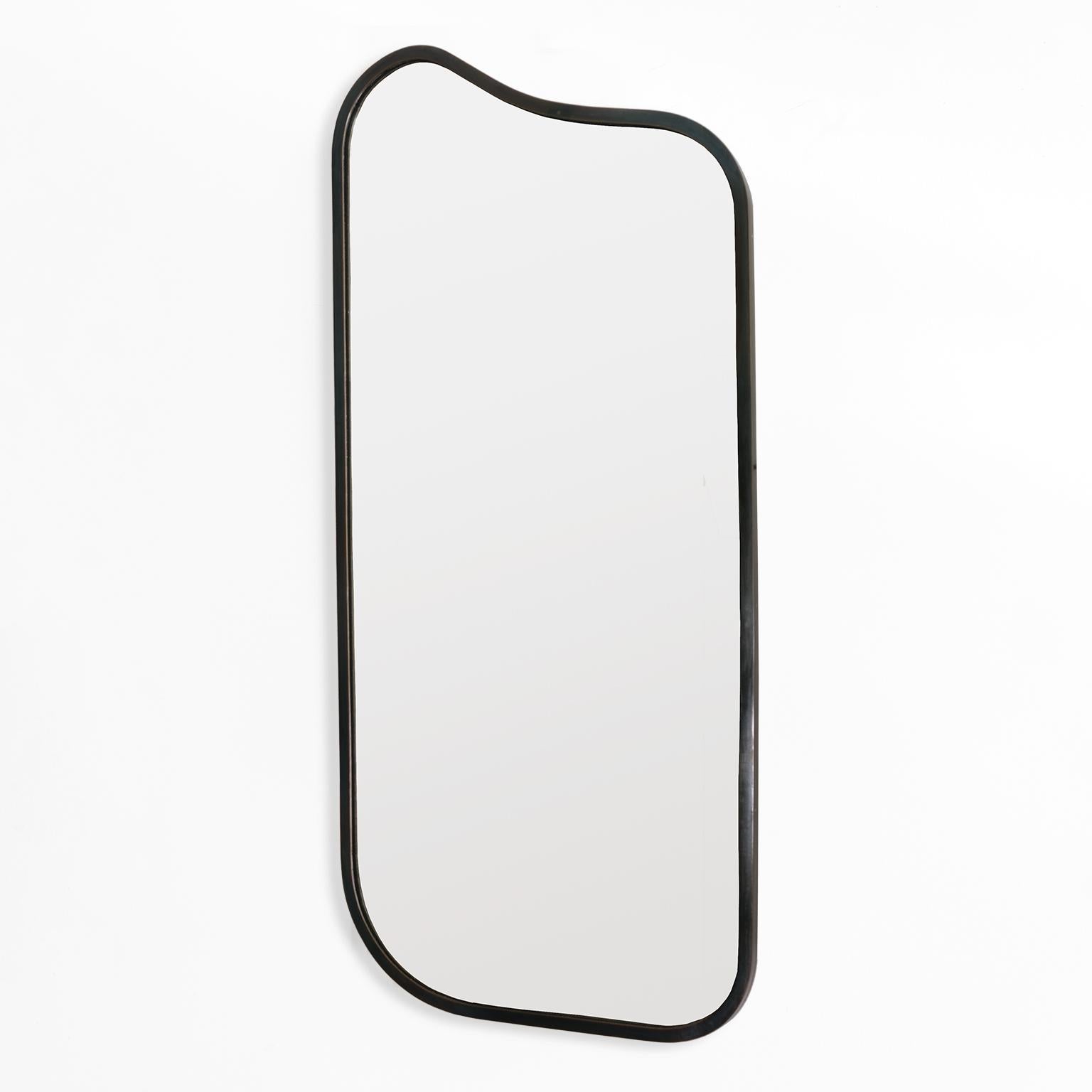 A Scandinavian modern patinated metal mirror with an asymmetrical shape. The mirror combines four unique curved corners to great effect. Made of polished steel the surface has a chromatic patina and a satin finish. 

Measures: Height: 40”, width’