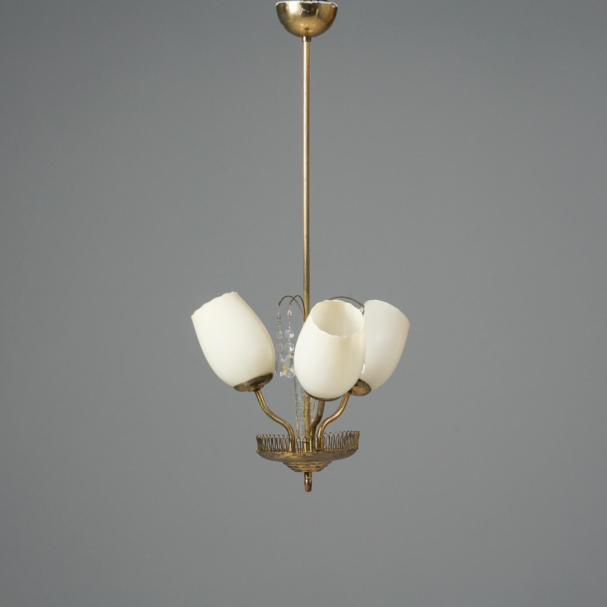Scandinavian Modern pendant, manufactured in Finland, 1950s. Brass frame, crystal details, glass shades. Good vintage condition, minor patina consistent with age and use. 