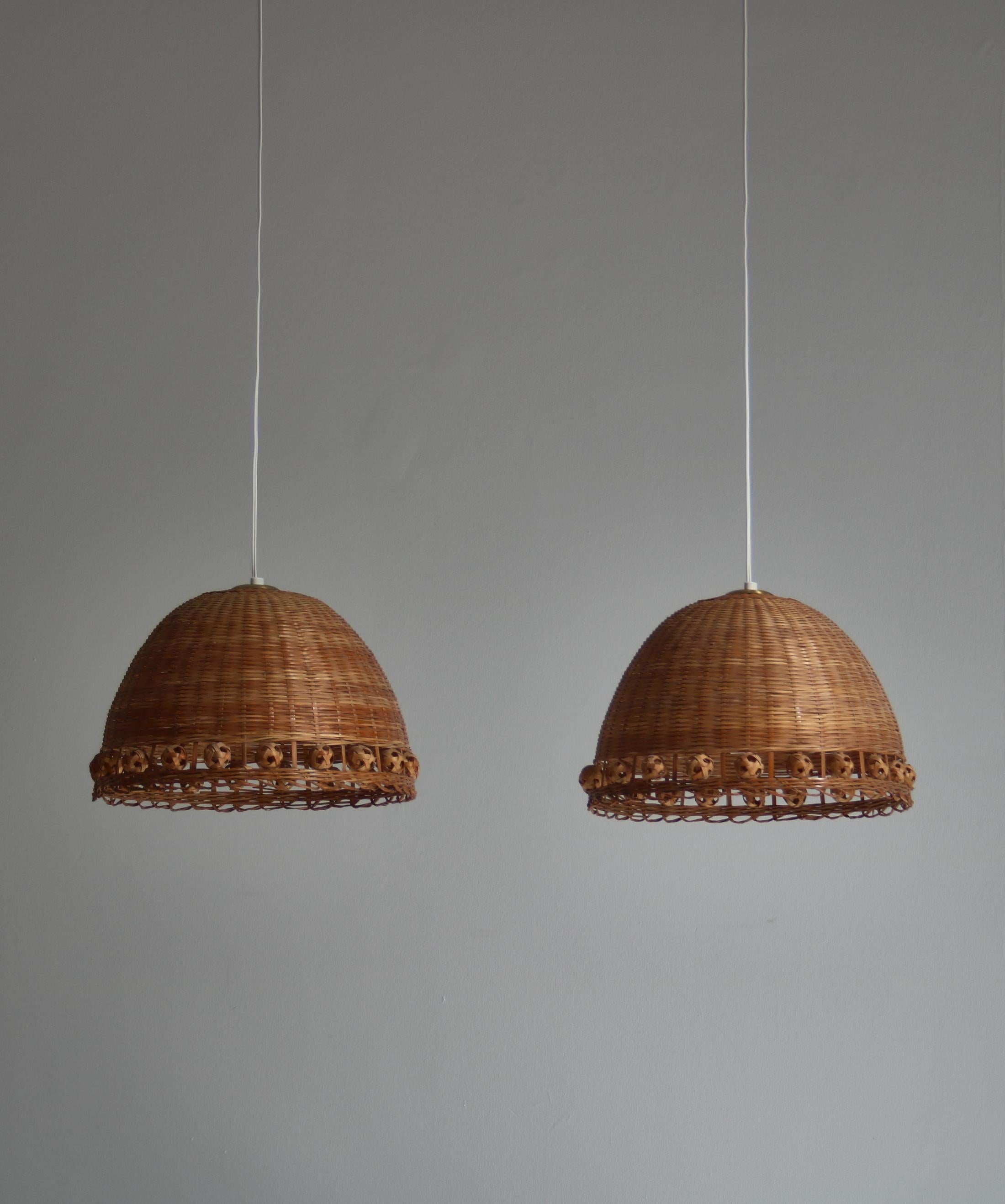 Wonderful set of vintage handmade wicker pendants made in the 1970s Denmark. The elegant and simple design and the woven cane creates a warm and very pleasant light.