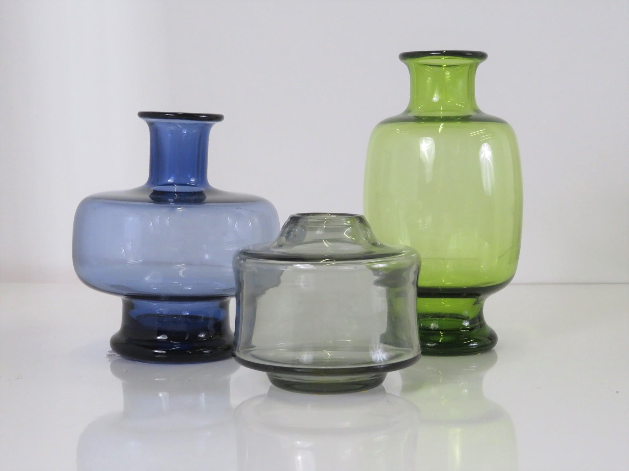 Lutken grouping of 3 blown glass vessels for the Danish firm Holmegaard from the late 1950s. The larger vase in Majgrön (May Green), the middle size in Safir (Safire) and the squat one in Gray. They all are engraved on the bottom with Per Lutken’s