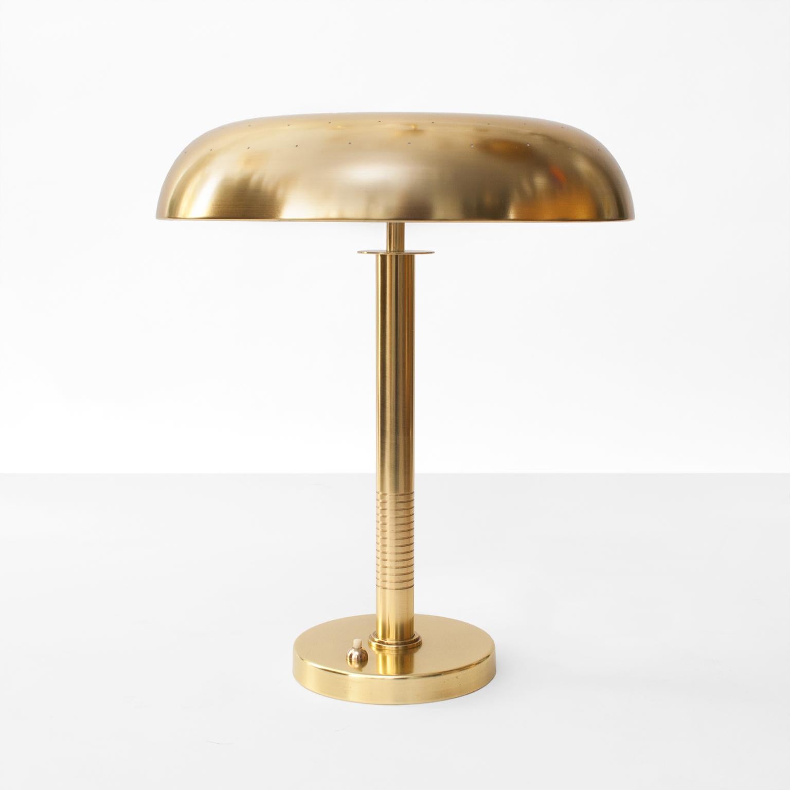 Scandinavian modern table / desk lamp by Bertil Brisborg for Bohlmarks, Sweden, circa 1950. Newly restored polished an lacquered brass, newly wired with 2 standard base sockets for use in the USA. Impressed manufacturer's mark to underside. Shade