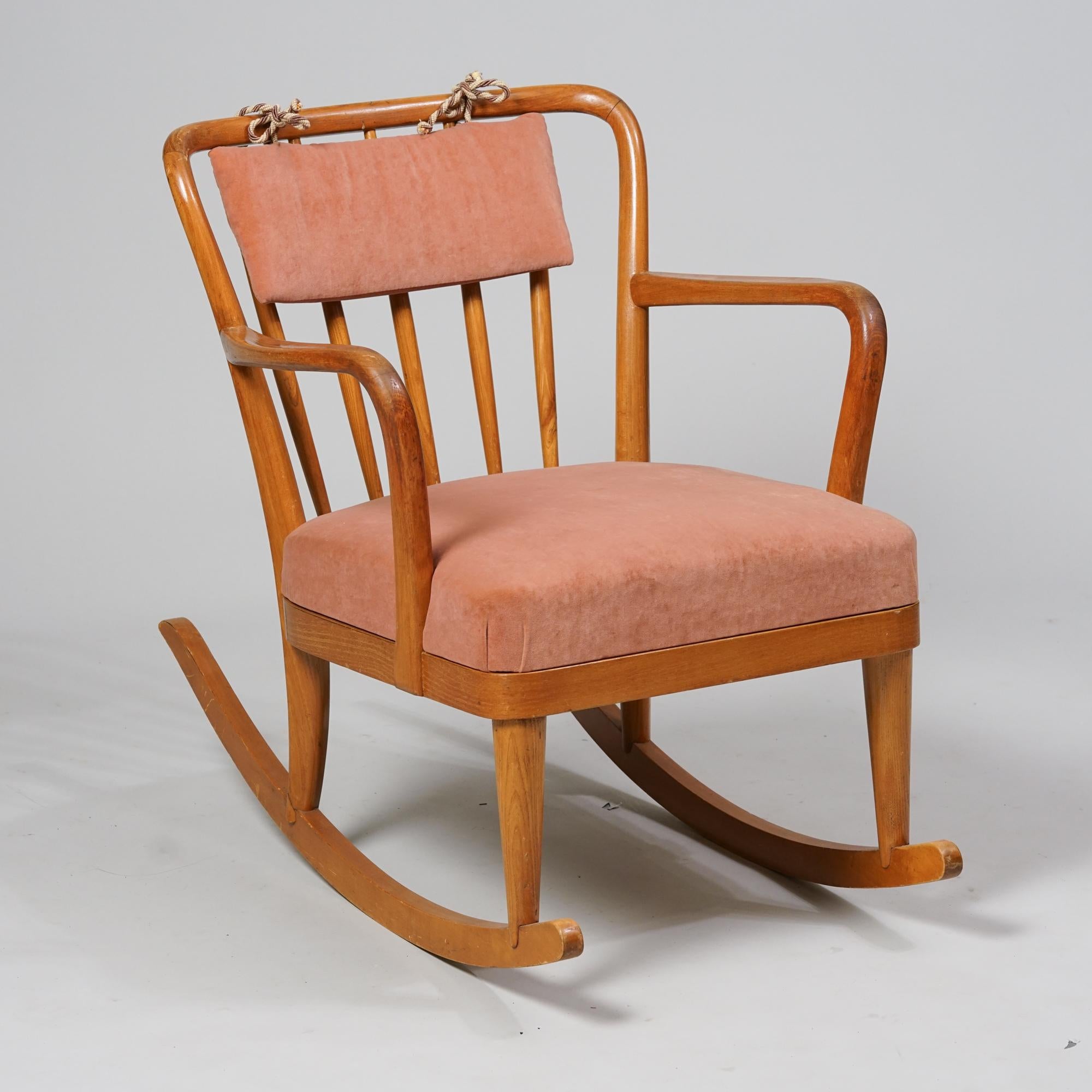 Scandinavian Modern rocking chair, designed by Carin Bryggman, 1940/1950s. Birch frame with beautiful salmon colored upholstery. The backrest pillow has been added later. Good vintage condition, patina consistent with age and use. Timeless