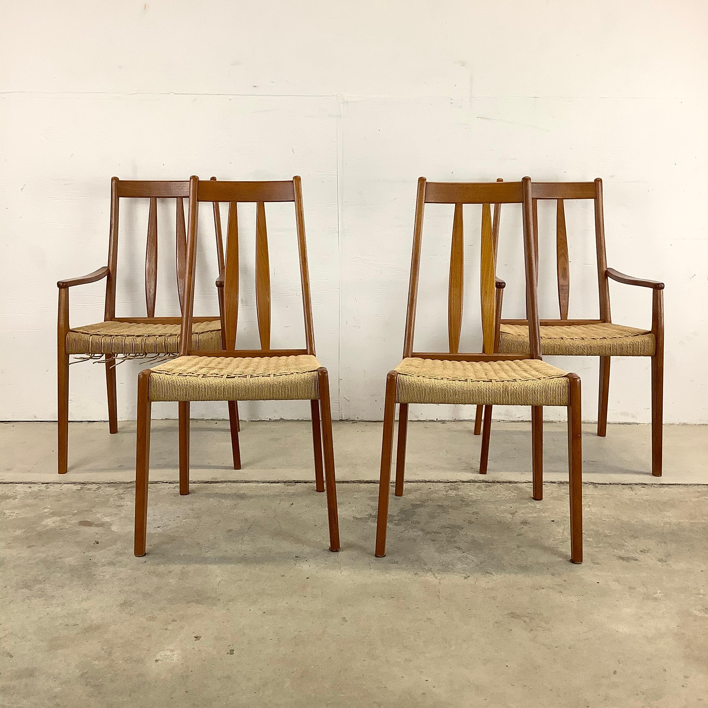 This striking set of four Scandinavian Modern teak dining chairs feature unique Mid-Century Modern design with vintage rope seats and sculpted slat seat backs. Comfortable matching set includes two armchairs and two side chairs- perfect set for