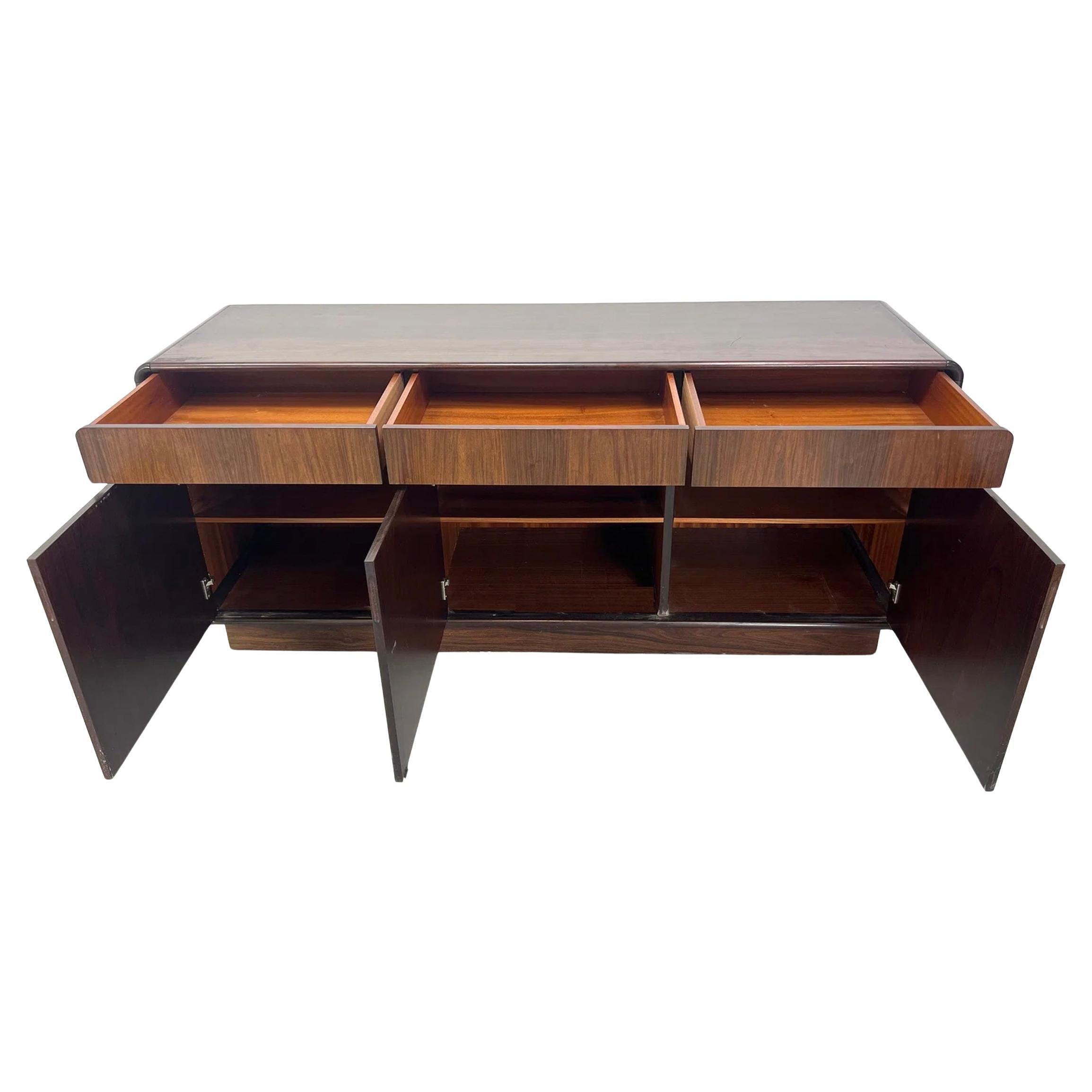 Scandinavian Modern rosewood 3 Drawer 3 Door Wide Credenza. Has 3 top drawers and 3 lower doors with adjustable shelves. Sits on a plinth base. Circa 1970s. Drawers have metal glide drawer slides with stops. Very Clean Ready for use.

Local Pick up