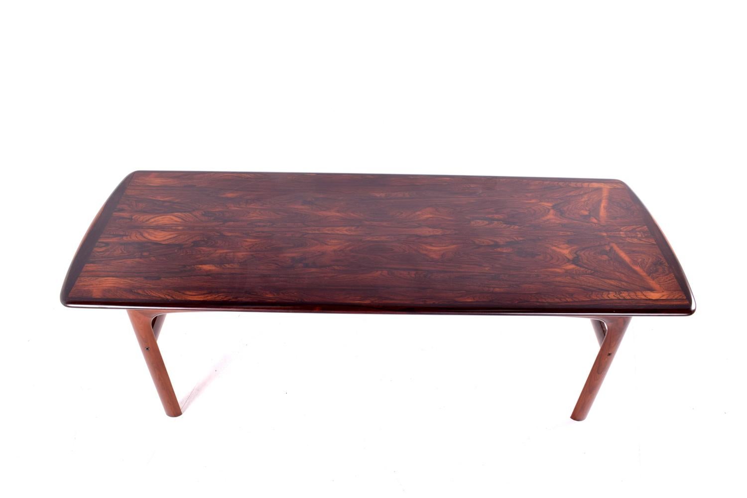 Mid-Century Modern coffee table manufactured by Westnofa of Norway. Table top features gorgeous rosewood grains wrapped with solid wood edge banding.
A delicate design with a very good construction and attention to details by Rasmus Solberg.