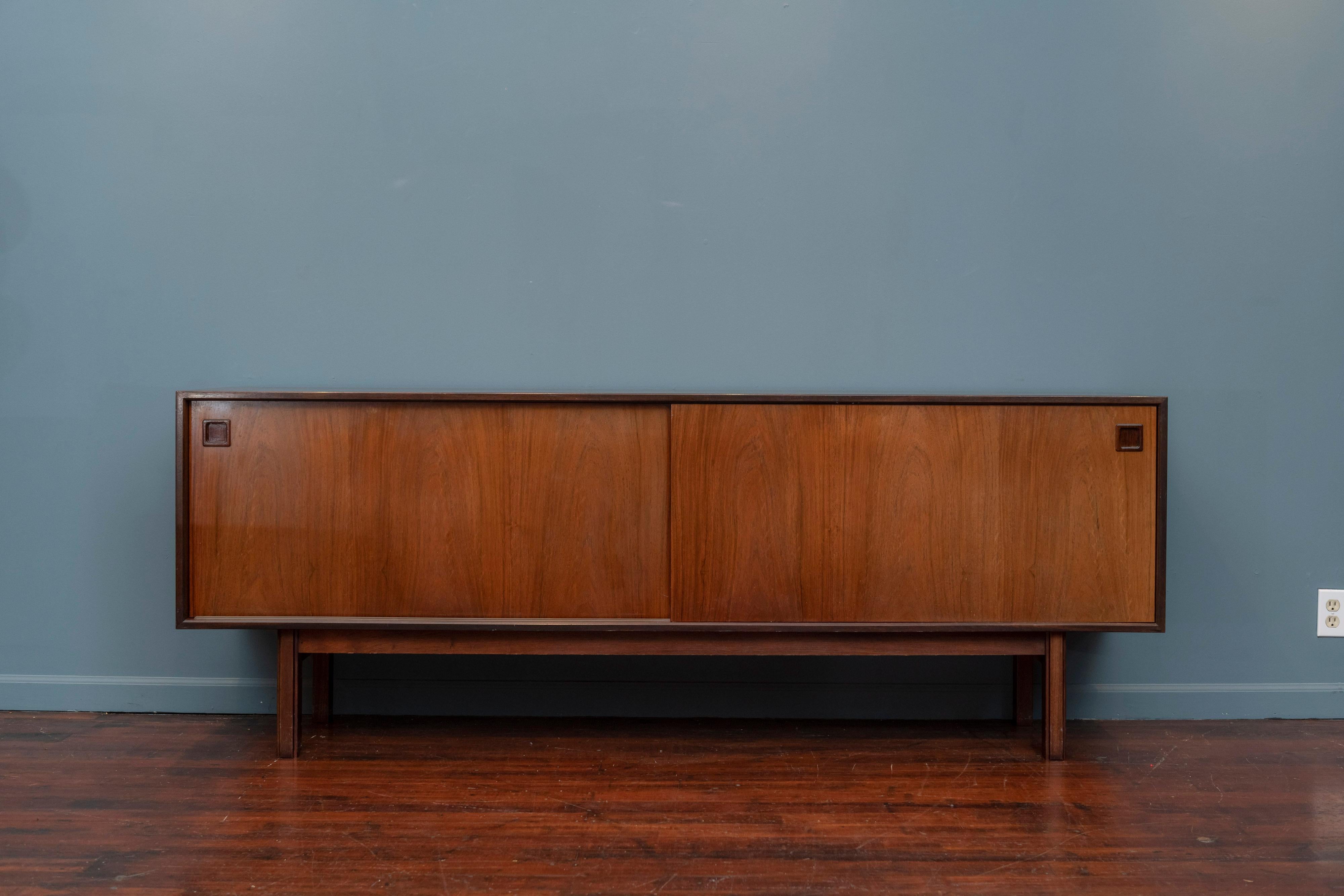Scandinavian Modern rosewood credenza designed by Gunni Omann for Omann Jun, Model 21.
 Elegant and clean design with two large doors that slide effortlessly with fitted interior drawers and shelves. Very good original condition, labeled.