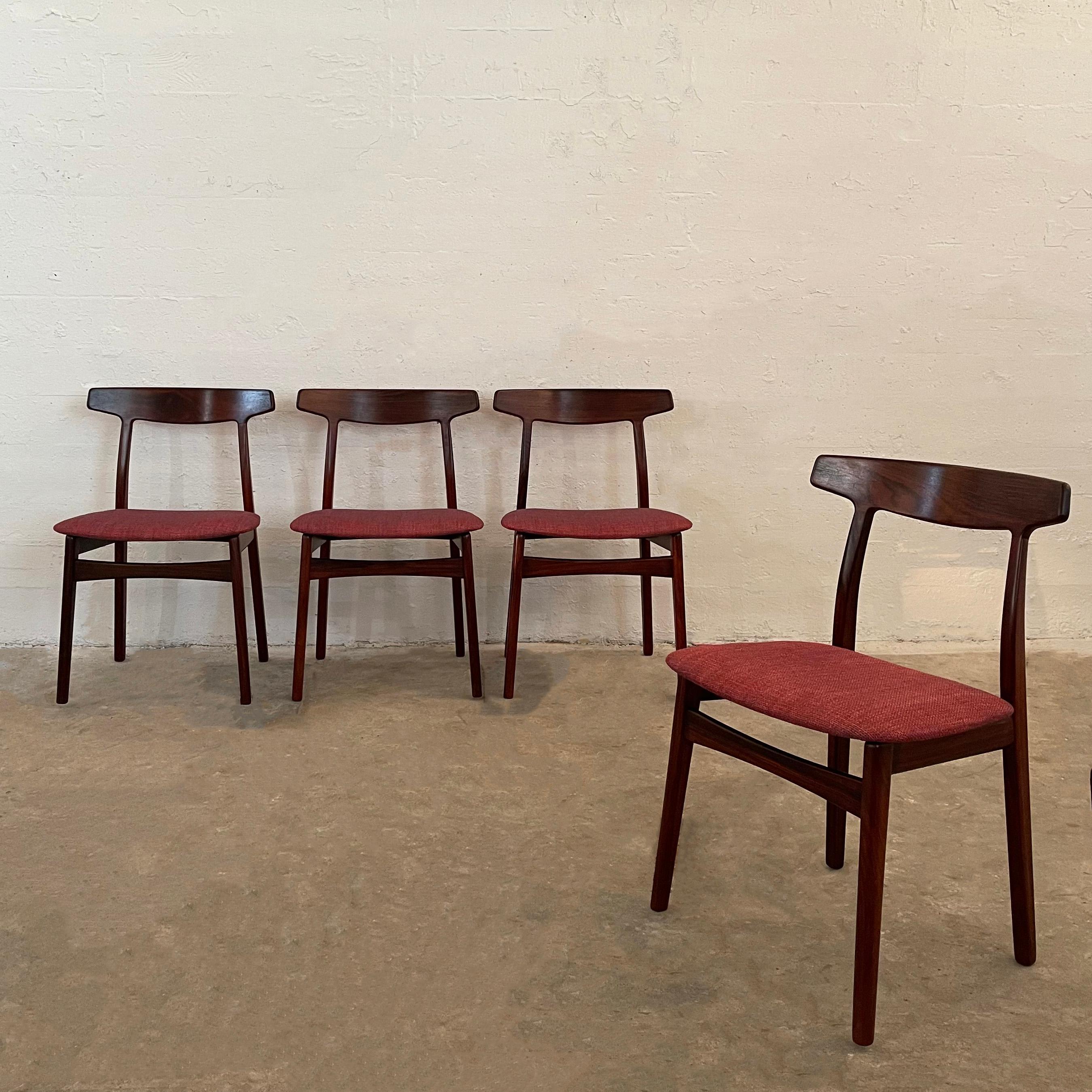 Set of four, Scandinavian modern, dining chairs designed by Danish architect Henning Kjaernulf for Bruno Hansen Møbelfabrik feature elegant rosewood frames with curved backrests and seats upholstered in raspberry tweed. The chairs are a beautiful