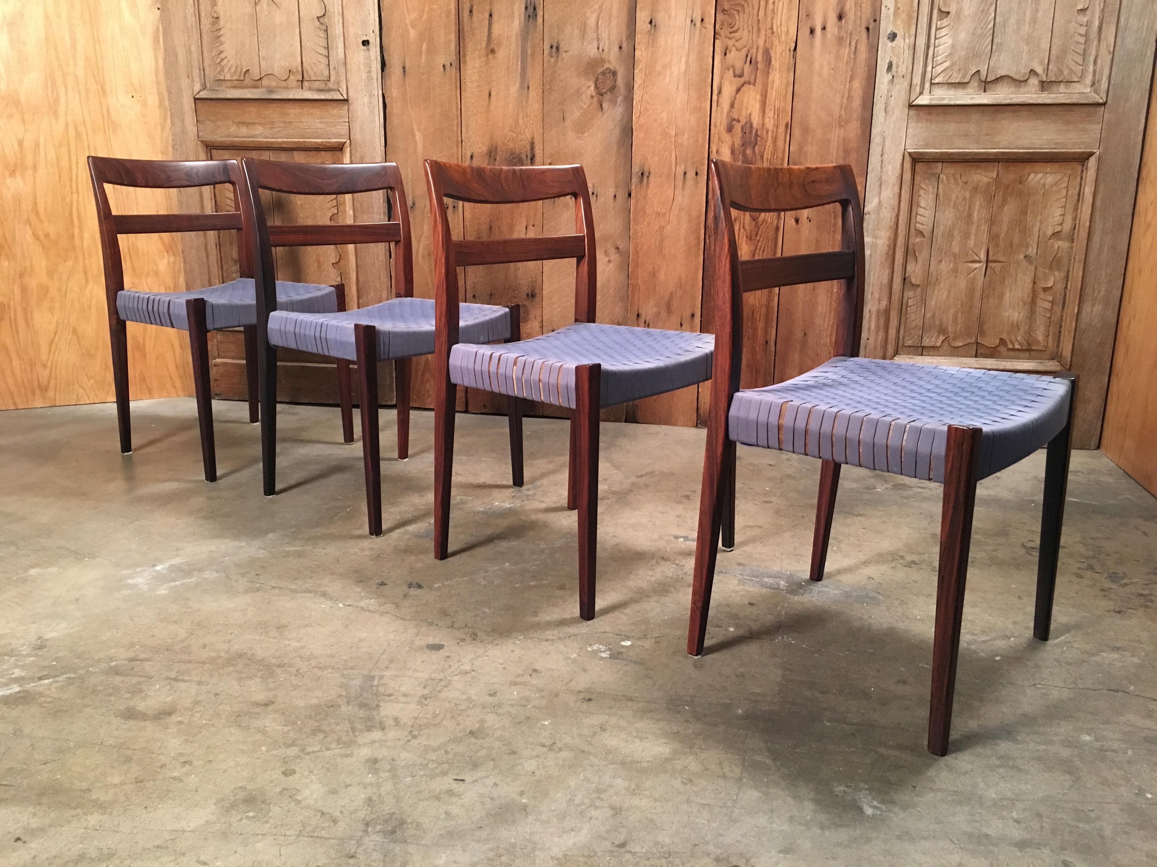 Set of four Mid-Century Modern dining chairs with woven web seats.