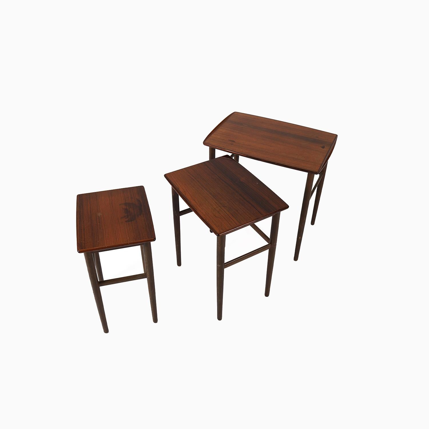 
This is a nested set of Danish side tables made in rosewood.  These lovely little tables have a sculpted ‘lip’ on the lateral edges.  They are yet to be restored– they are waiting for a finish update and will be restored prior to going to their new