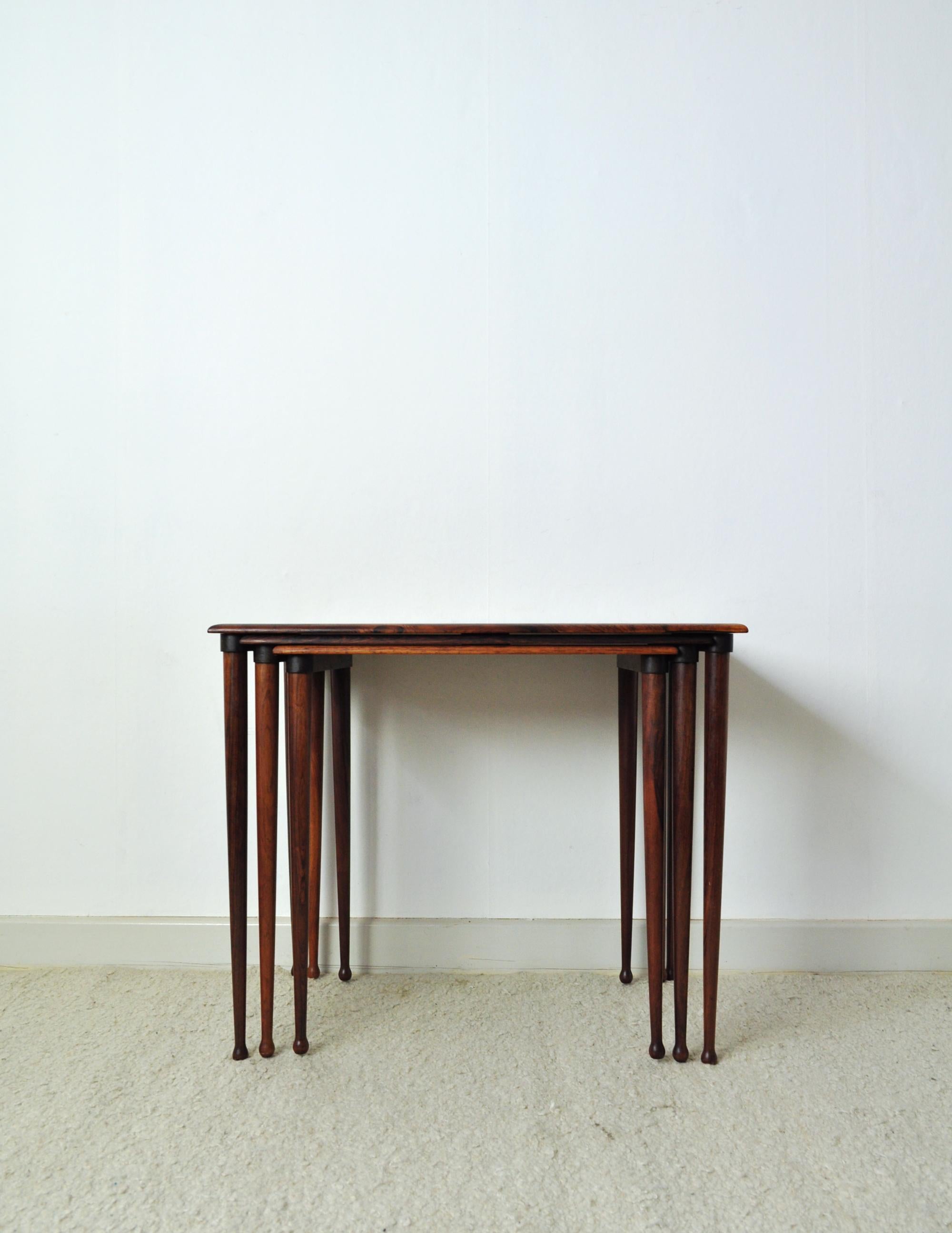 Scandinavian Modern nesting tables with drumstick legs in rosewood by Danish BC Møbler. Labeled by maker and Danish Furniture makers control.
Fine vintage condition with small signs of wear.
Dimensions:
H 49.5 cm x W 60 cm x D 38 cm
H 48 cm x W
