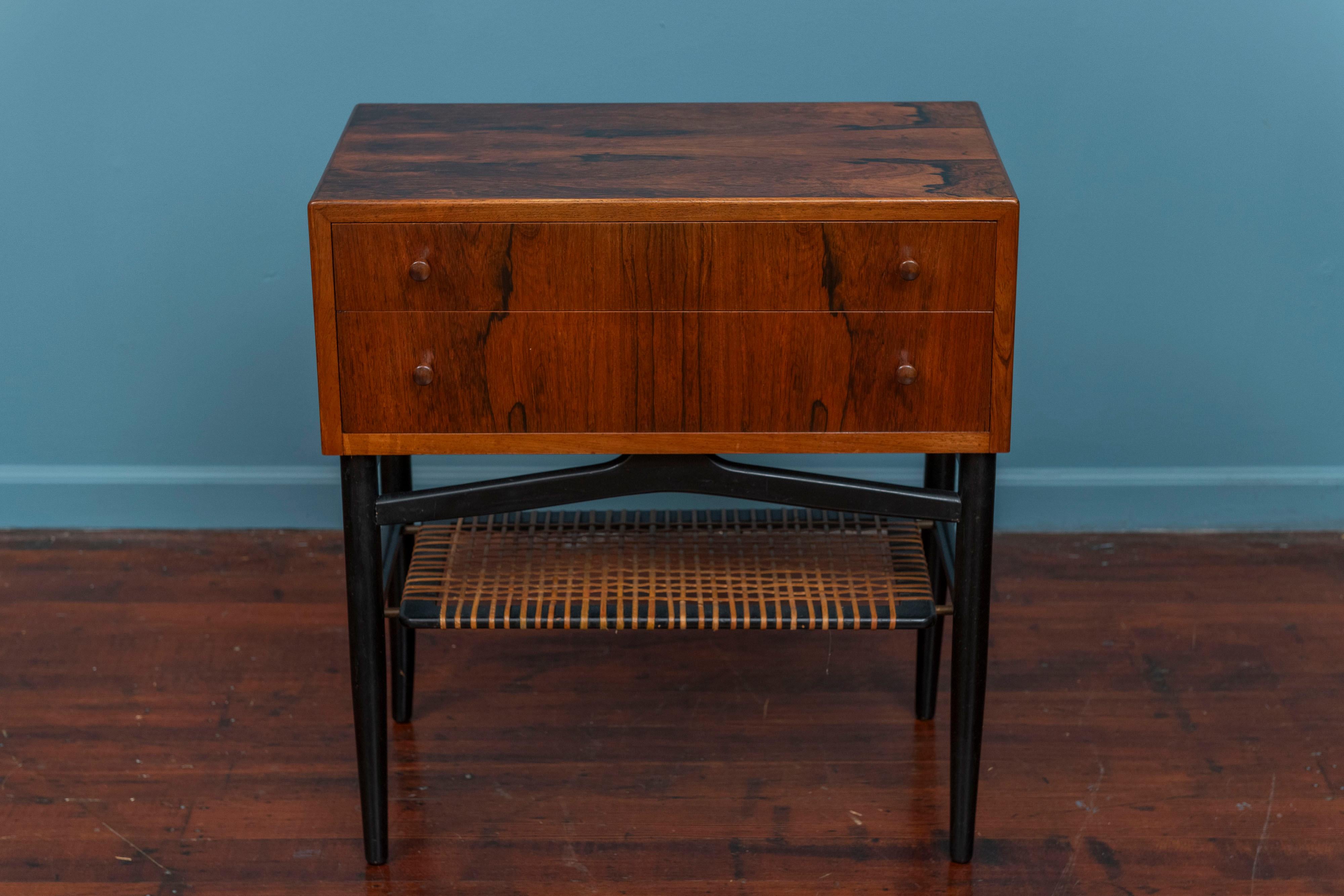 Scandinavian Modern rosewood console or small cabinet. Beautiful rosewood grain throughout two drawer cabinet on an ebonized and cane base. High quality construction and attention to detail, ready to install and enjoy.