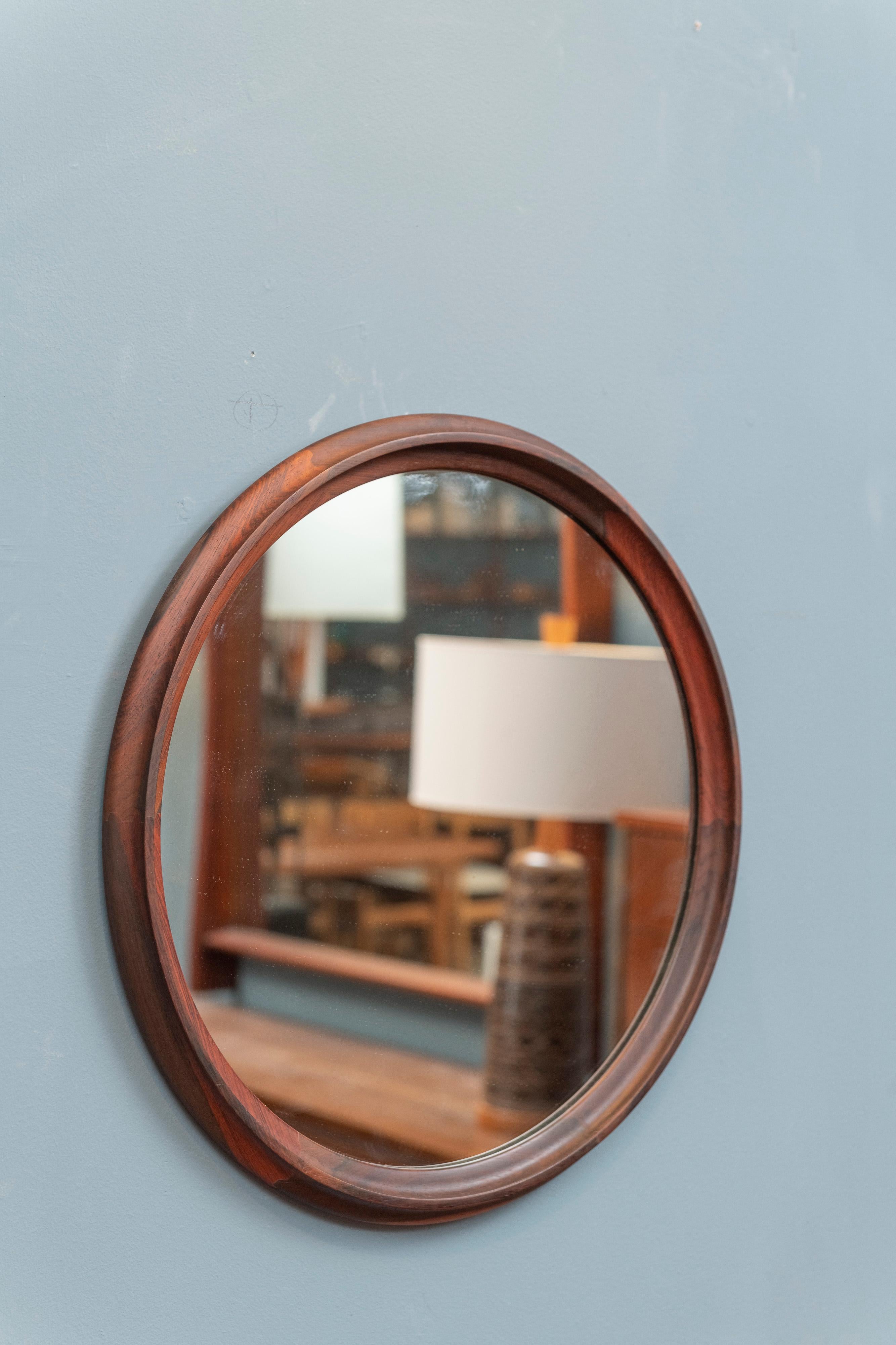 Scandinavian Modern pair of rosewood sculpted edge rosewood wall mirrors, Denmark. High quality construction and attention to design, ready to enjoy.