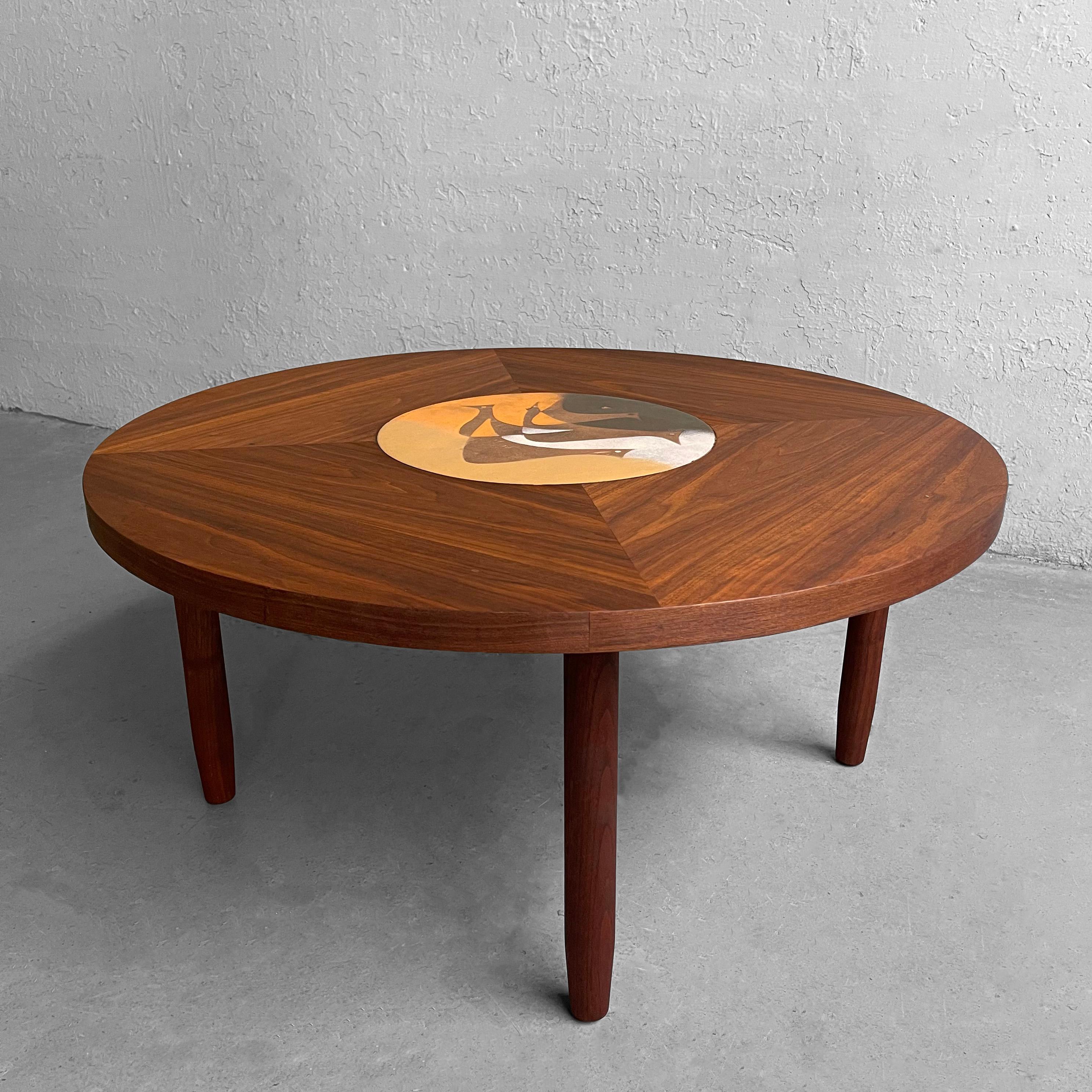 Scandinavian modern, round, walnut coffee table features a segmented top with abstract enamel bird inlay detail.
