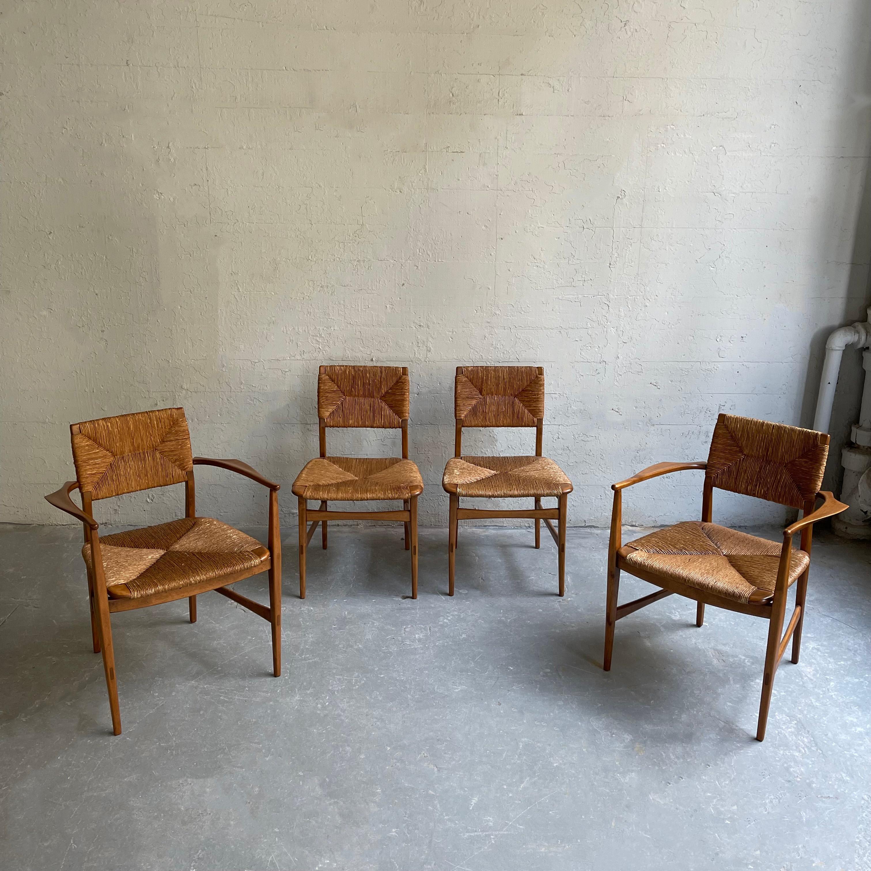Set of 4, Scandinavian modern, beech wood dining chairs feature woven rush seats and backs. The set consists of 2 captain arrmchairs that measure 23.5 inches w and 2 side chairs that measure 19 inches W.