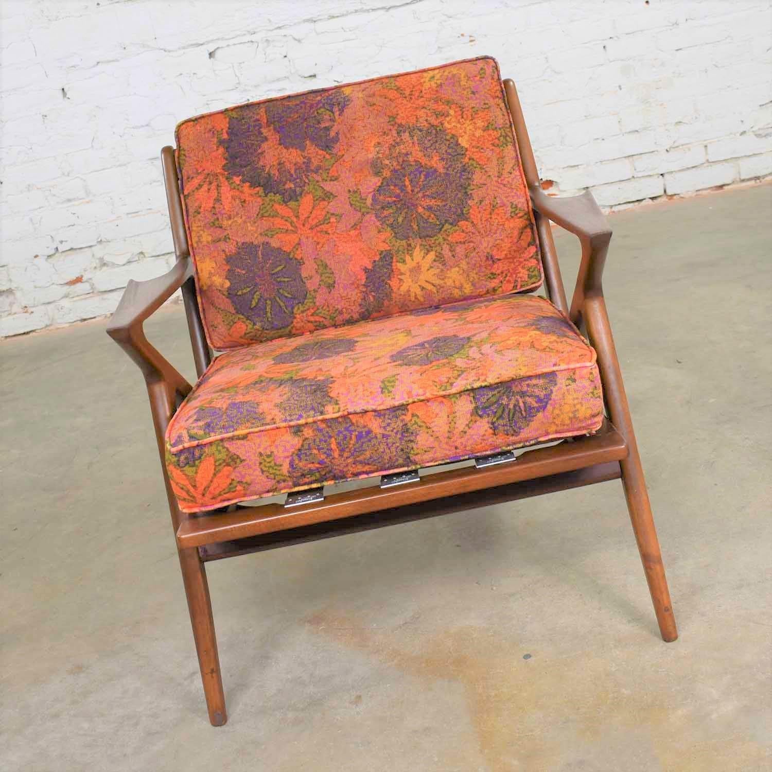 Incredible Scandinavian Modern Z-lounge chair designed by Poul Jensen for Selig. It is wearing its original mod floral fabric in a red, orange, purple, yellow mix. It is in fabulous restored condition. You may still see a couple very small places on