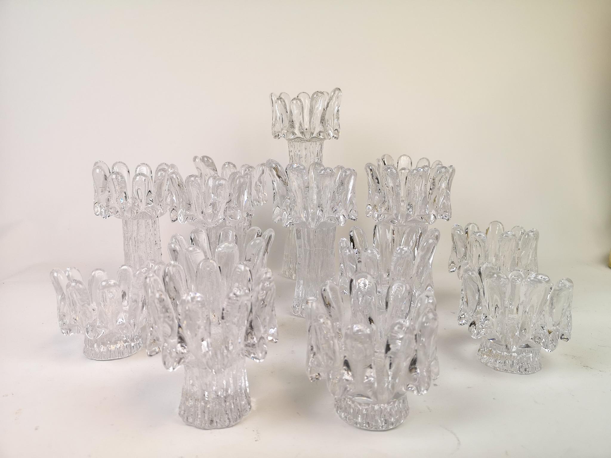 A nice set of 14 candlesticks from Kosta signed Göran Wärff and with the name Sunflower. Nice set of 14 candlestick holders handmade in the Kosta factory. Together as a group this set makes a wonderful edition to any kind of room.

The high one H