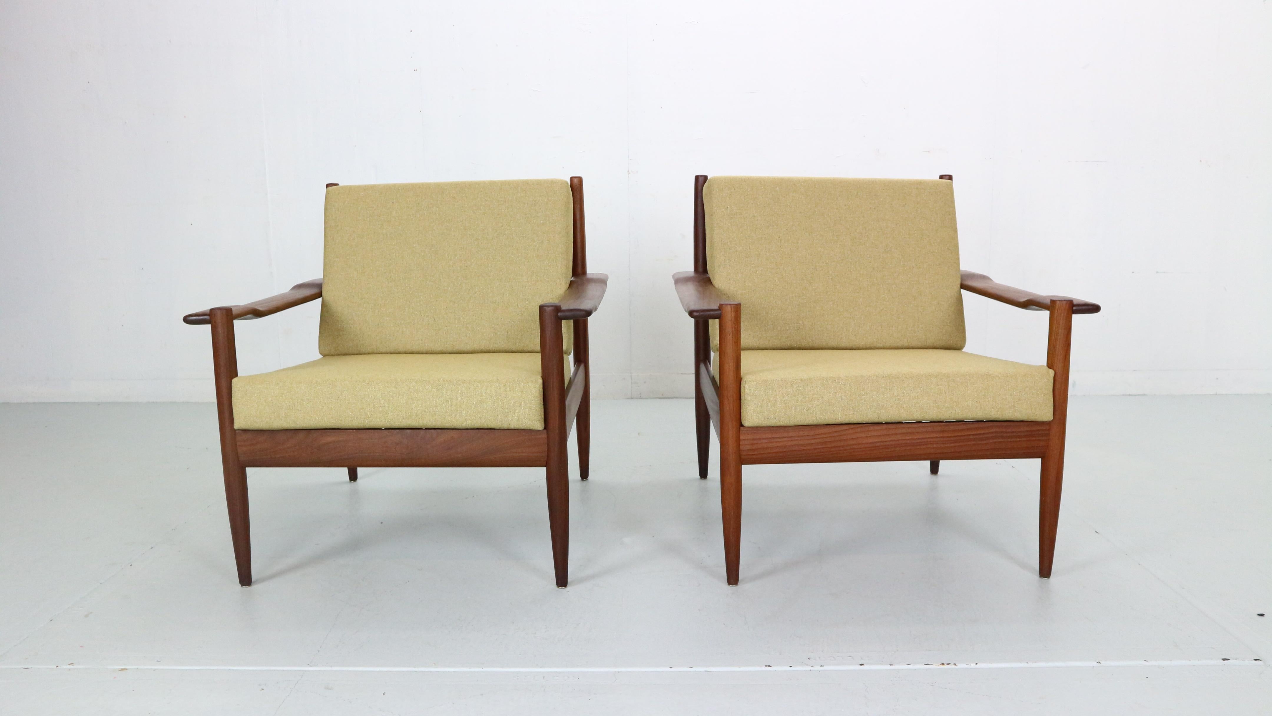 Scandinavian modern period set off two lounge chairs made in 1960's period, Denmark. 
The frame of the chairs are made of solid teak wood, with curved armrests and open back rests. 
The cushions has been newly reupholstered in light warm yellow