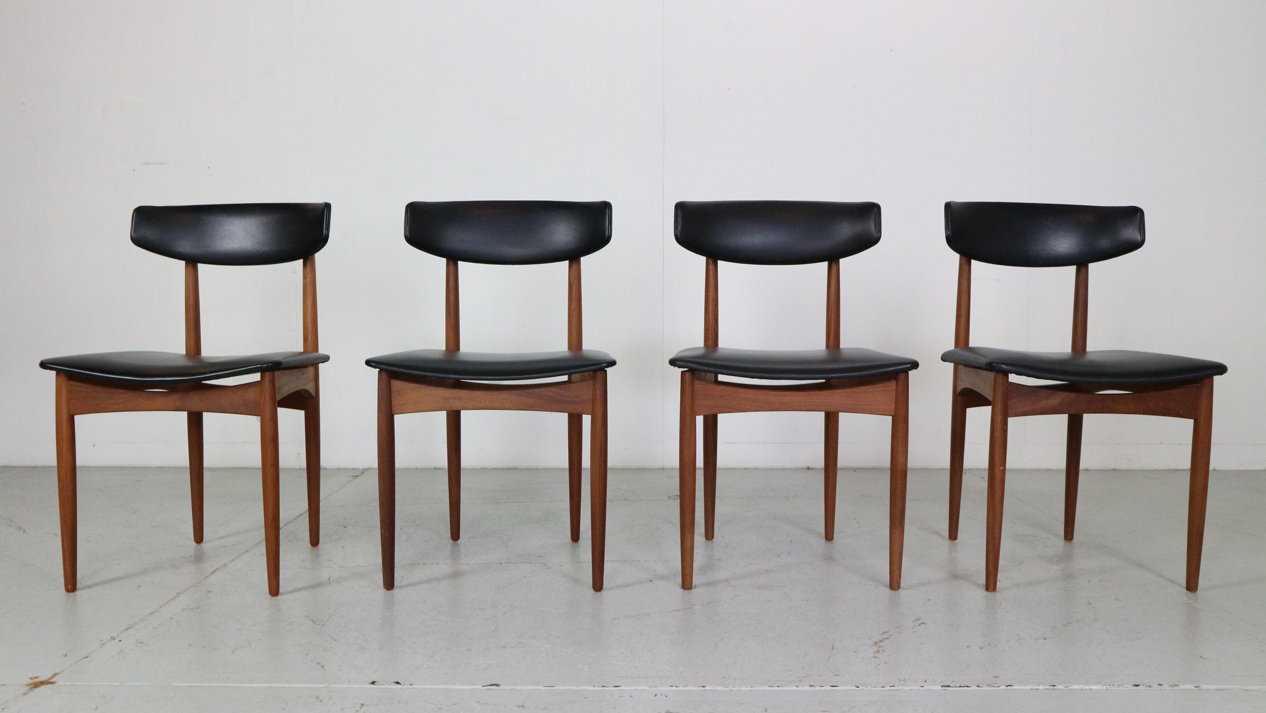 Scandinavian modern period set of 4 dining room chairs made in 1960s, Denmark. 
This set is in a great original condition.
Frame is made of curved solid teak wood. 
And very comfortable seating and back rests are upholstered in black faux leather.


