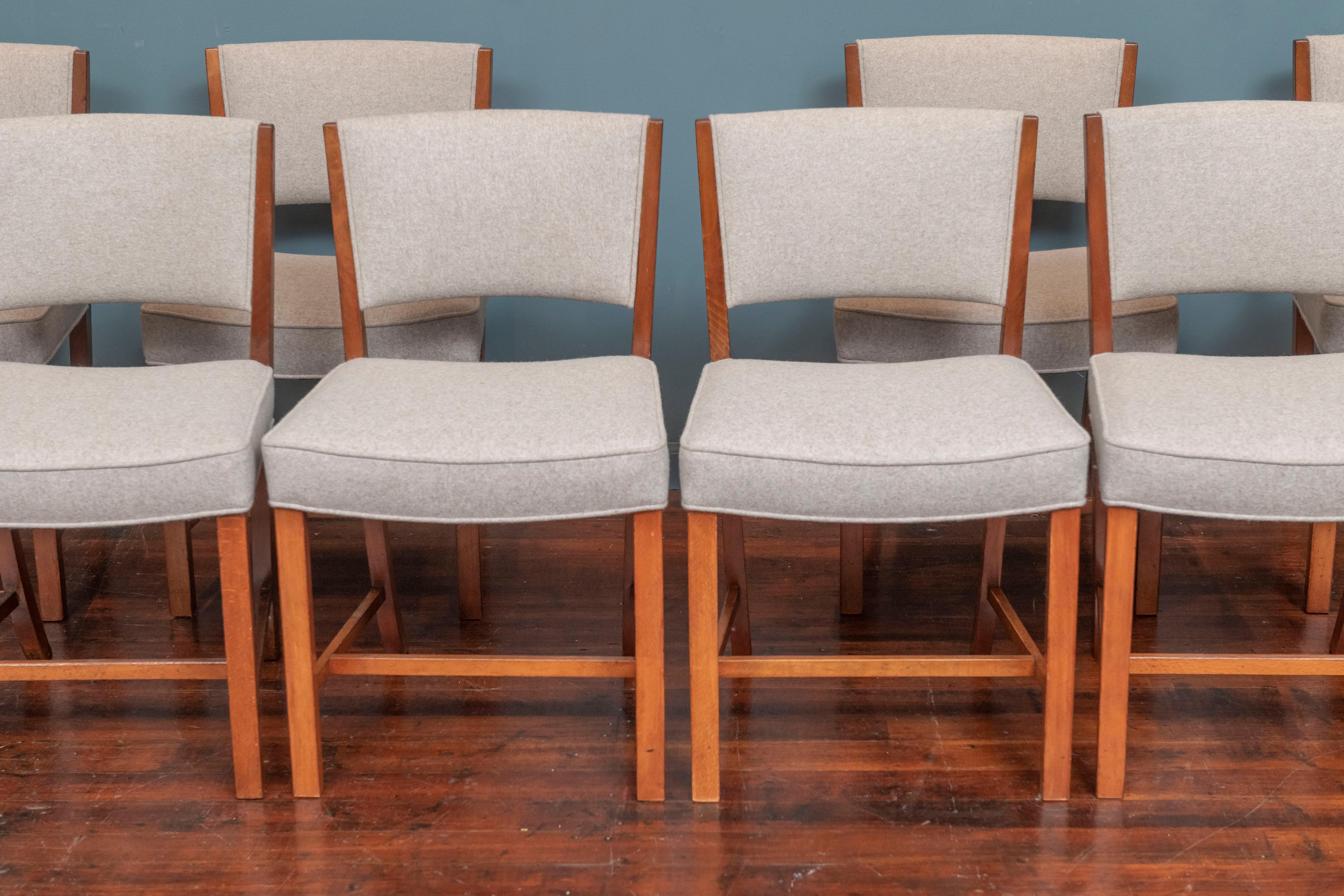 Scandinavian Modern set of eight dining chairs for Fritz Hansen, Denmark.
 Newly upholstered in a Maharam neutral wool felt upholstery, strengthened and refreshed fruitwood frames. Very comfy and ready to enjoy.