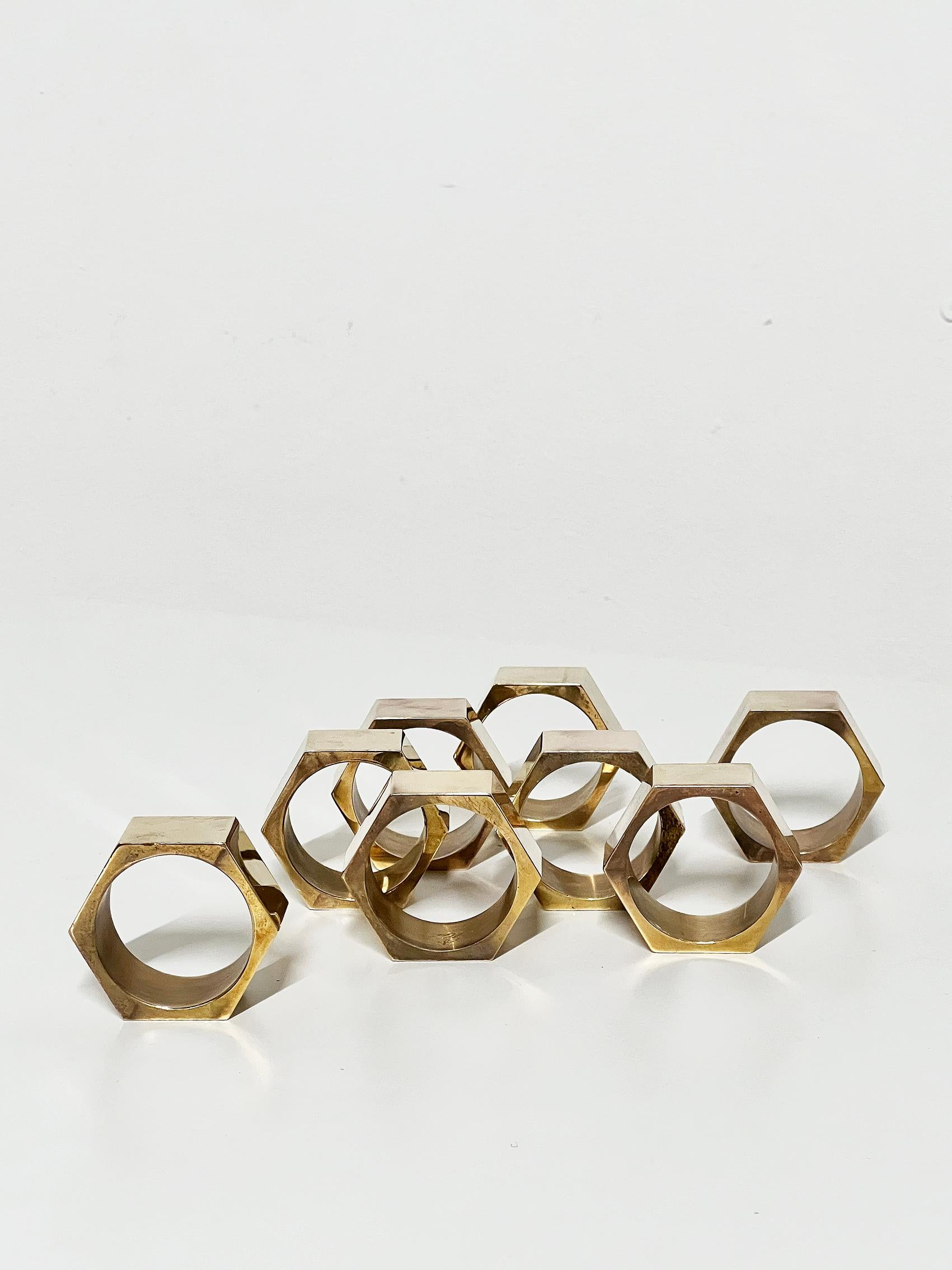 Scandinavian Modern set of eight napkin rings or holders, Gusums Bruk -1985.
Good vintage condition, wear and patina consistent with age and use. 
Brass patina, scratches.