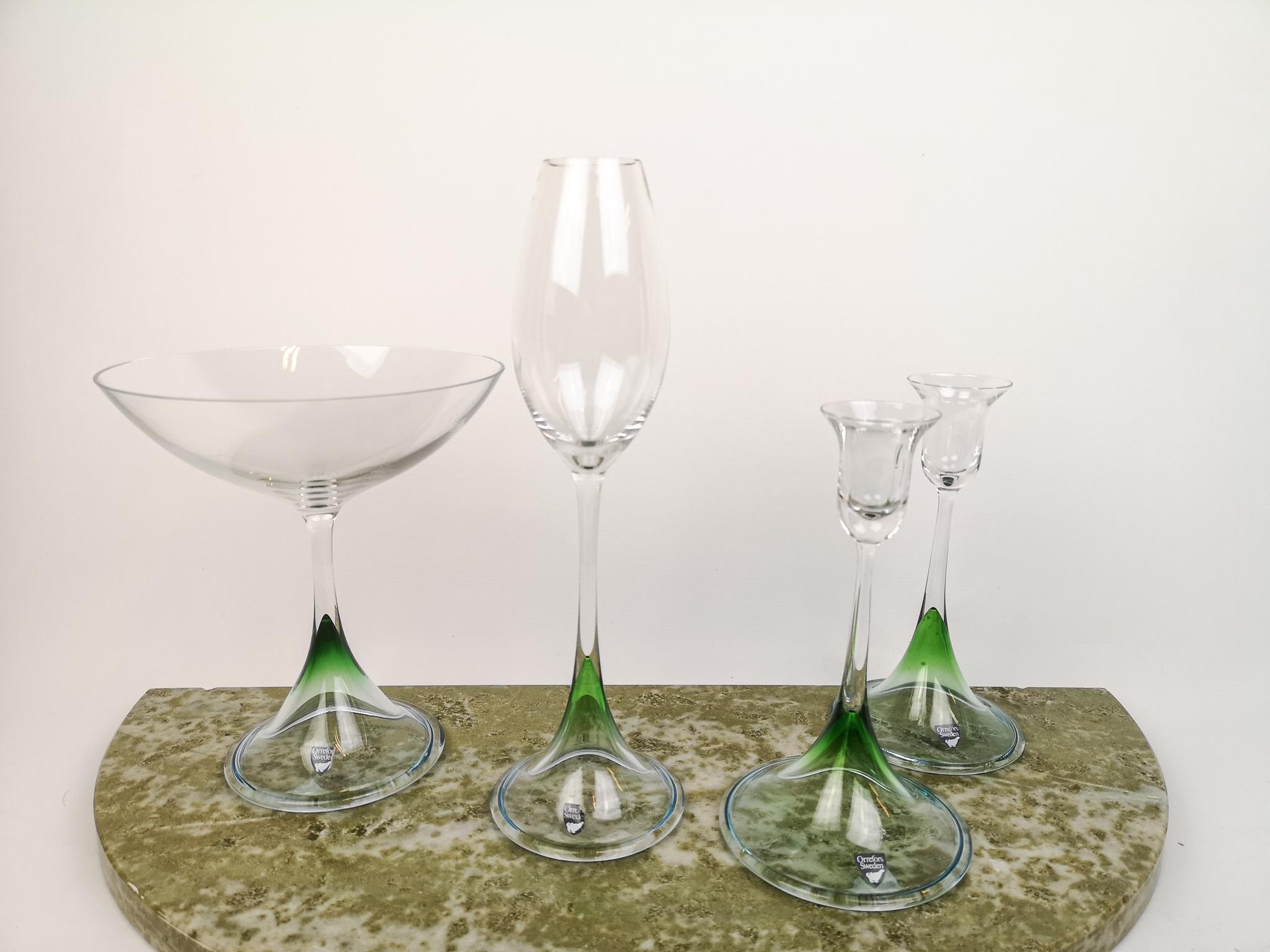 Wonderful pieces of tulip glasses in green clear glass design. Made by Orrefors in Sweden and design by Erika Lagerbielke.
There is a bowl on foot, a high tulip glass and two candlestick holders. The all match each other.

Very good condition and