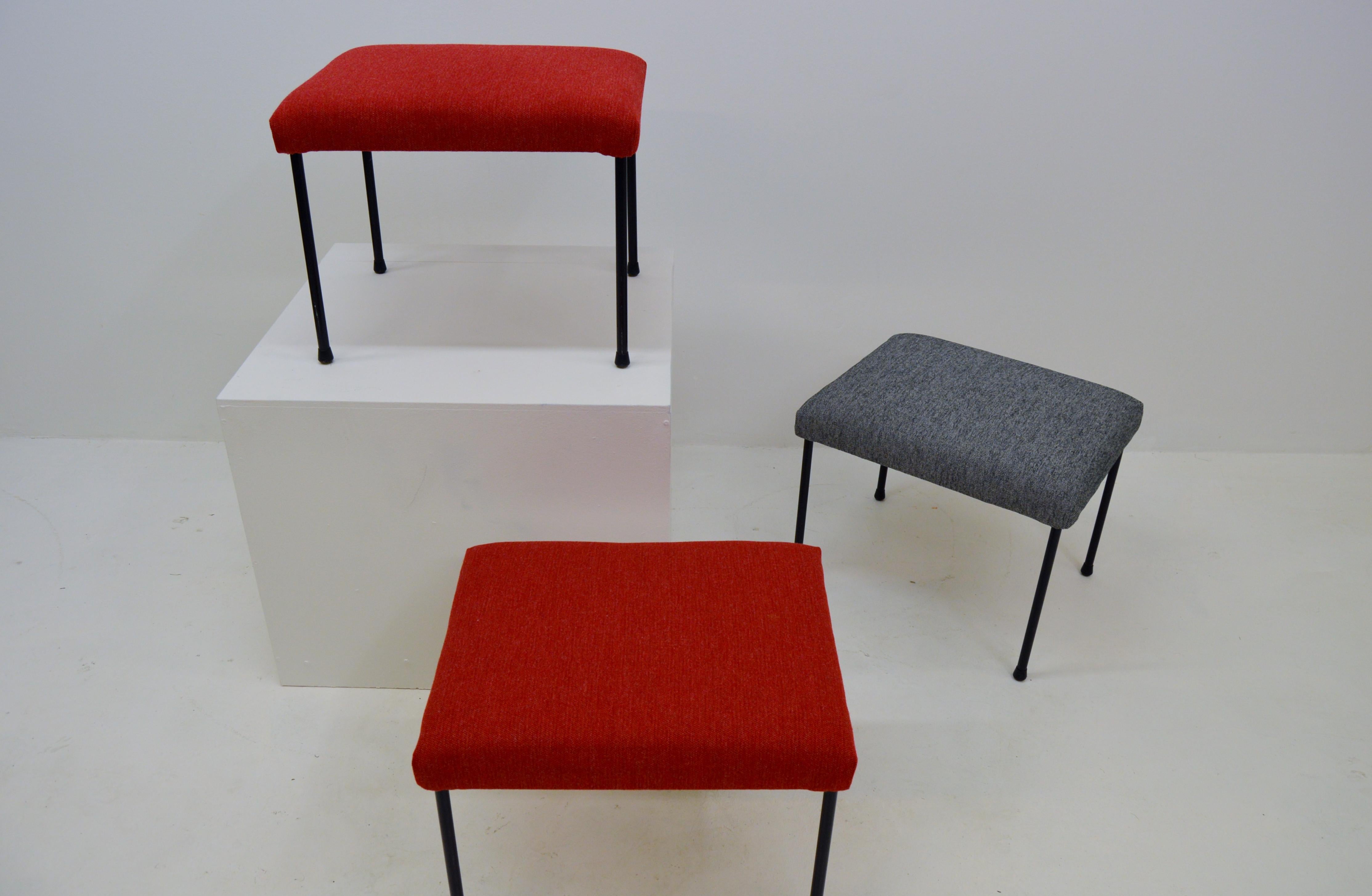 Set of three footstools / ottomans. They can be used individually or form a bench. The stools are newly upholstered in quality fabric. The legs are made of metal and the seat has fabrics, foam and webbing. Midcentury, designed and produced in Sweden