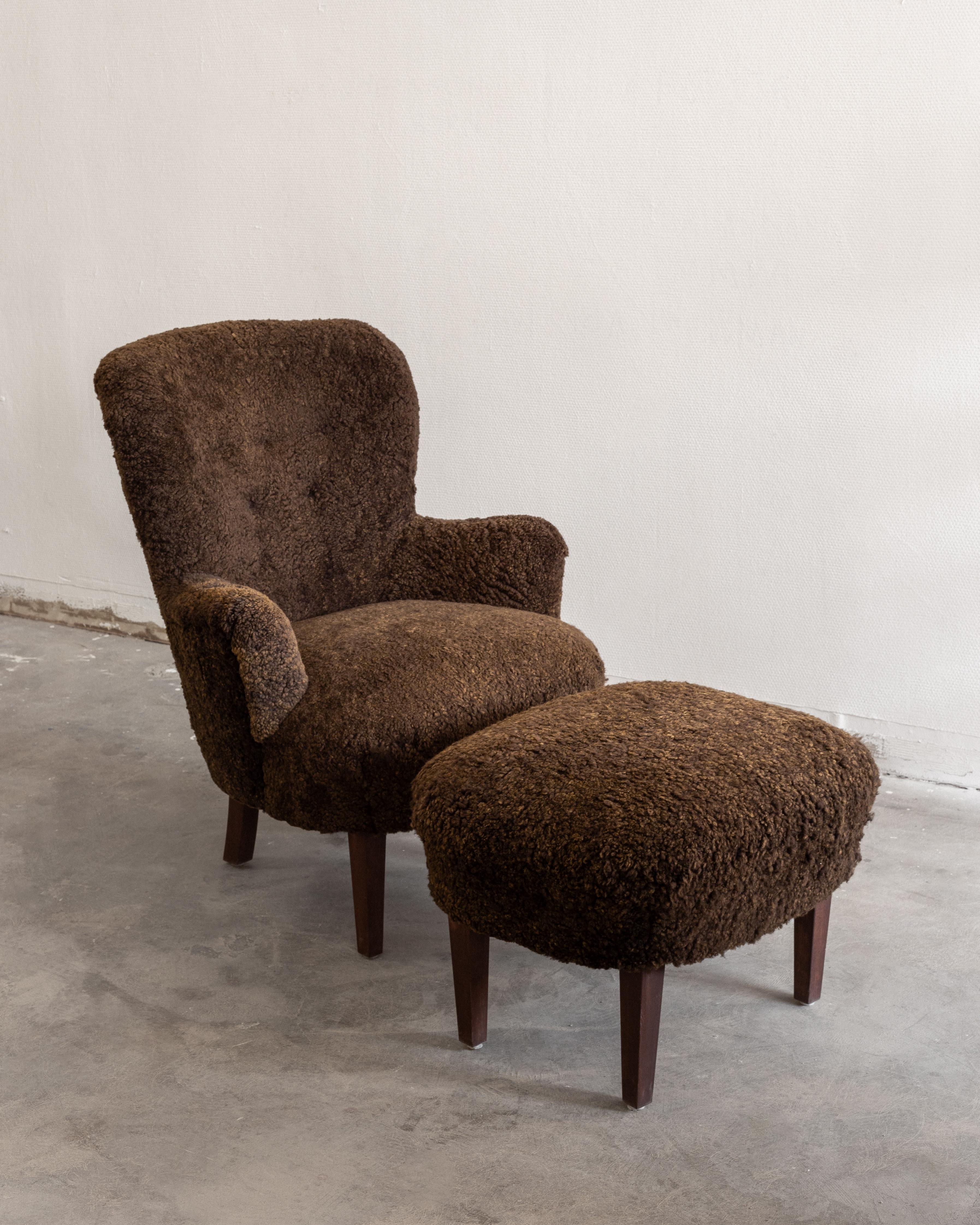 This rare vintage wingback lounge chair with a matching ottoman is a stunning example of Scandinavian Modern design, crafted in the 1940s, Sweden. 

It features an elegant, curved backrest and dark brown-stained wooden legs. Both the chair and