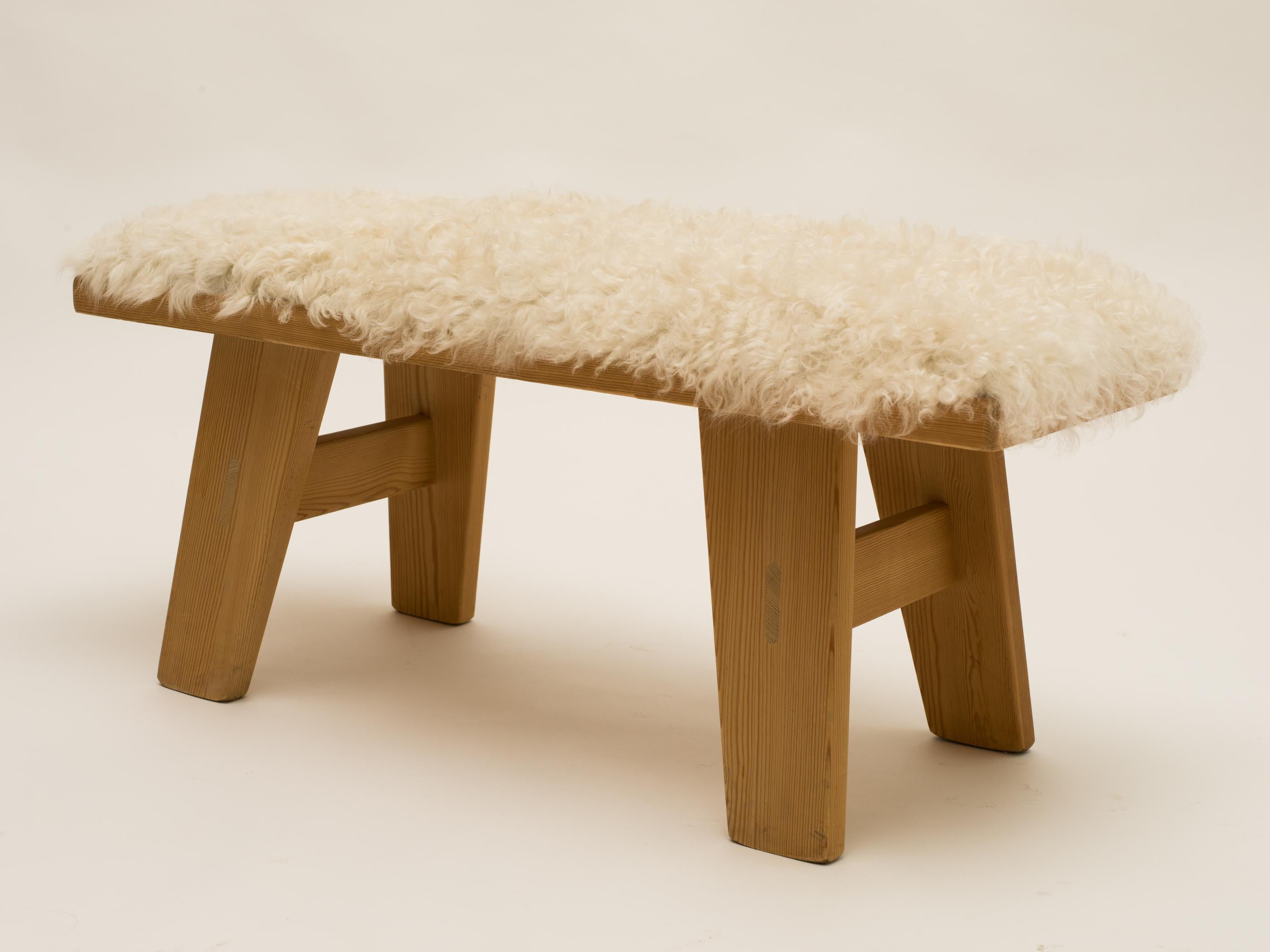 Scandinavian Modern sheepskin and pine bench by Krogenæs, Norway, 1960s Massive pine bench made by Krogenæs, Norway 1960s, with new upholstery in long haired sheepskin. The beautifully colored & grained vintage pine matches well with the soft
