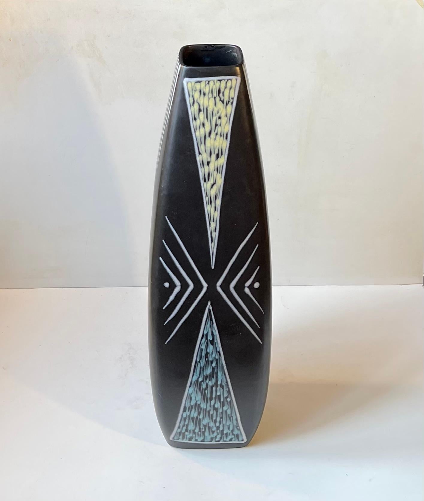 - Burgundia floor vase designed by Svend Aage Holm-Sorensen 
- Black main glaze with white and pastel geometric decor by Svend Aage Jensen 
- Manufactured by Søholm in Denmark from 1956 
- Nice intact vintage condition only tiny repair to the top