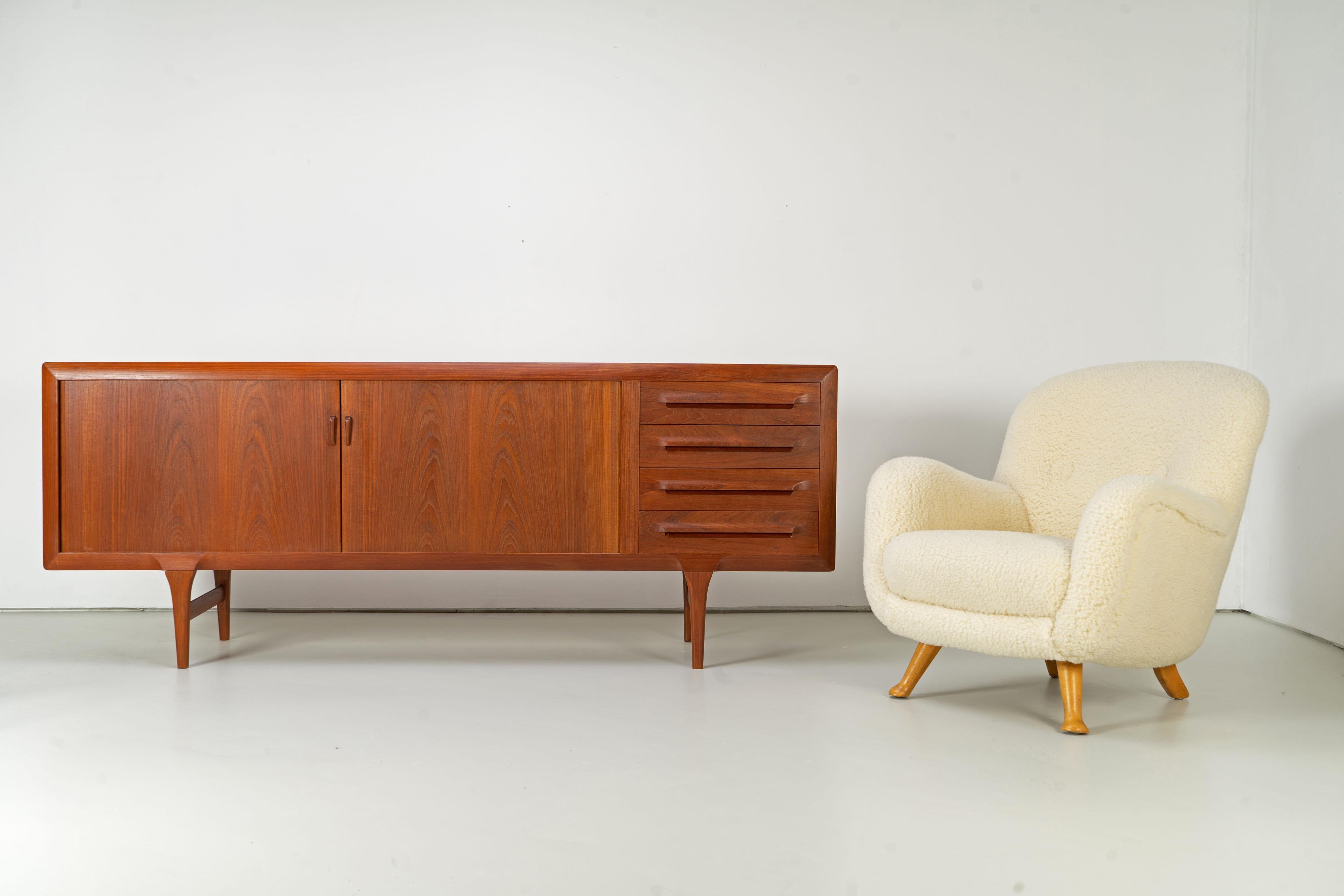 Mid-Century Modern sideboard by Ib Kofod-Larsen for the Danish furniture manufacturer Faarup. The sideboard features tambour doors and is veneered on all sides, thus it could be used as a roomdivider. It is in very good condition with slight signs